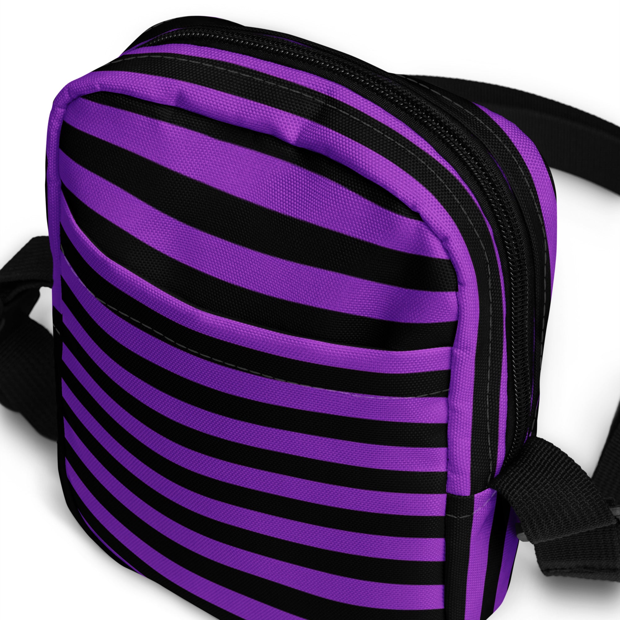 Girls purple and black striped halloween crossbody purse with zipper closure made of fabric for easy carrying