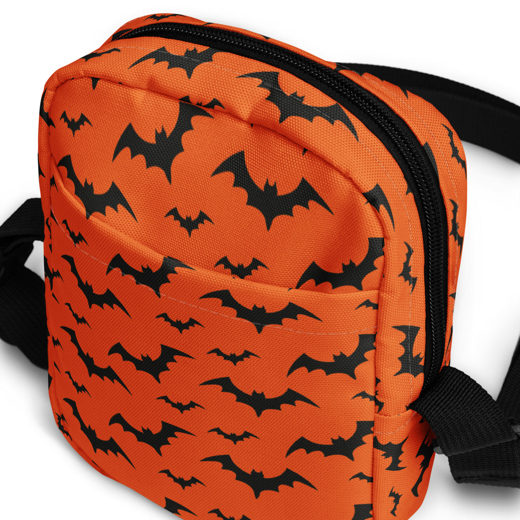 Kids orange halloween crossbody purse with black bat patterns and a black zipper for festive use