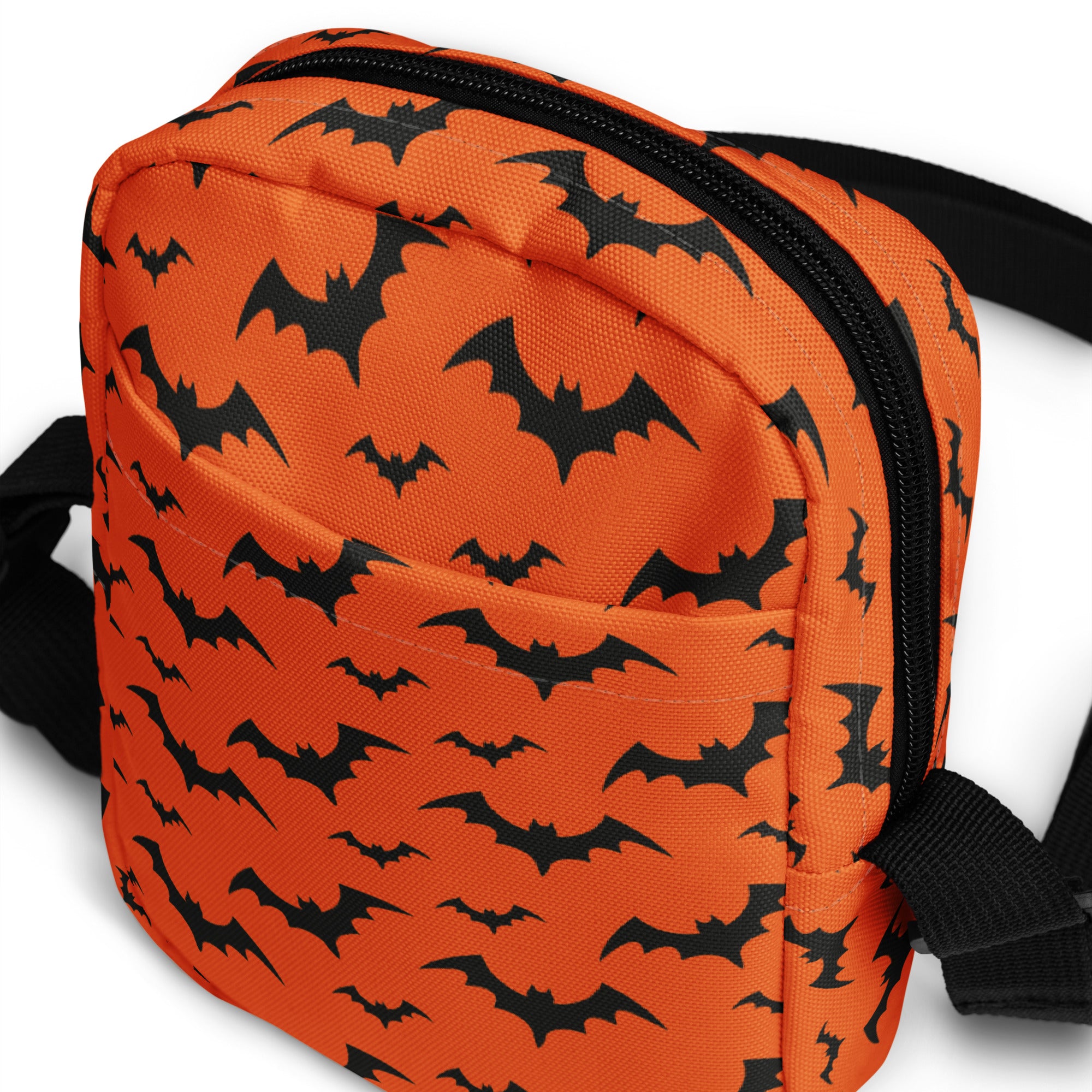 Kids orange halloween crossbody purse with black bat patterns and a black zipper for festive use