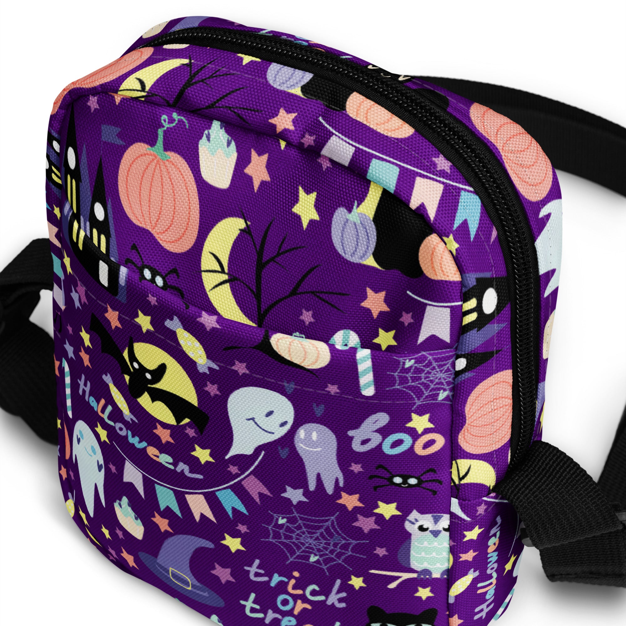 Girls spooky halloween crossbody purse in purple with black straps and zipper featuring playful halloween illustrations