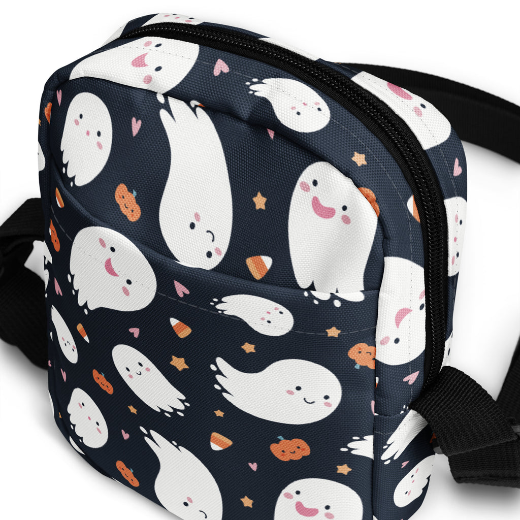A navy blue kids ghost Halloween crossbody purse with playful white ghosts orange pumpkins and pink hearts pattern