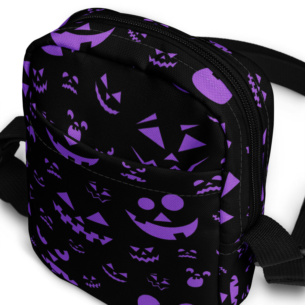 Black fabric crossbody bag with purple jack-o-lantern and pumpkin faces for girls halloween use