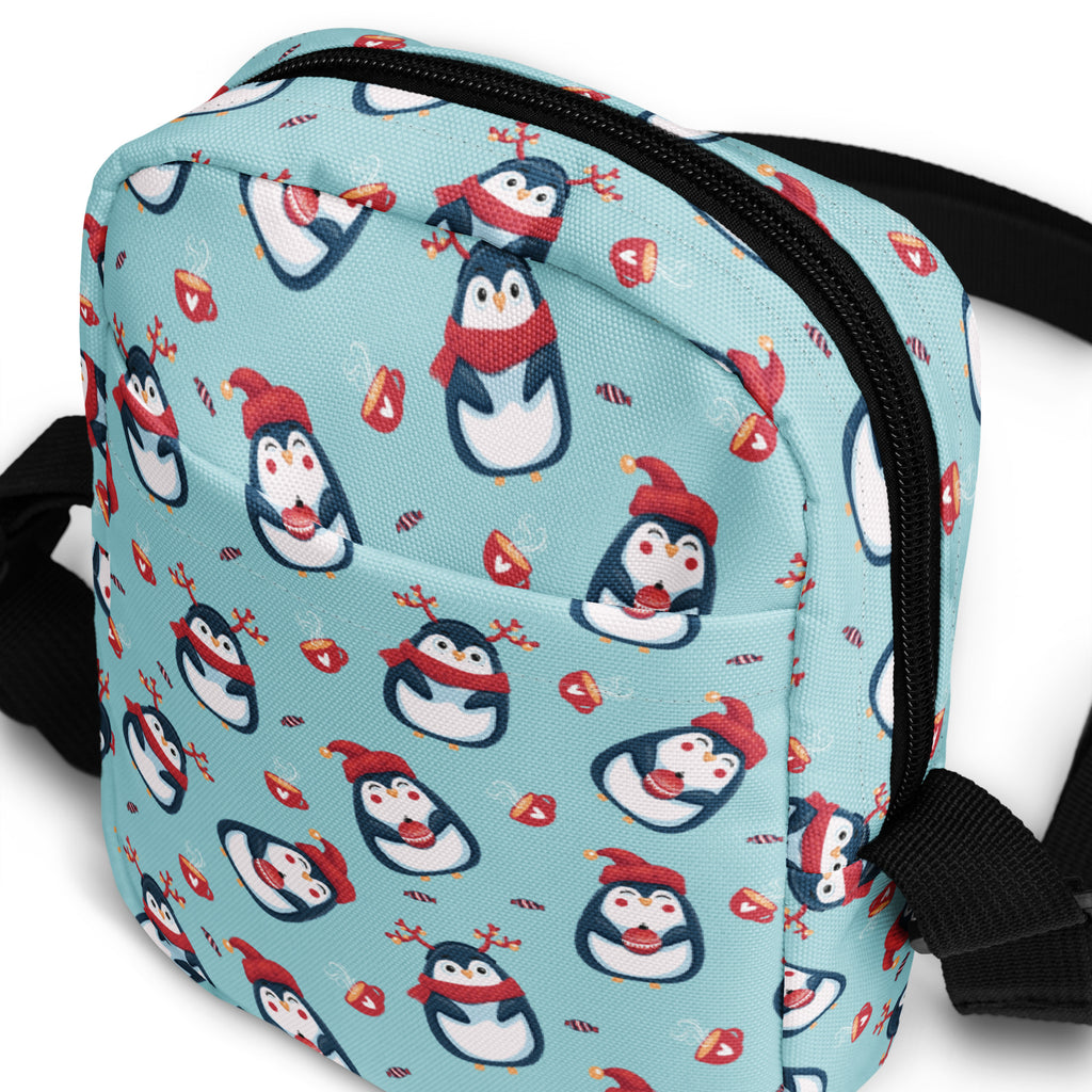 Girls reindeer penguin crossbody purse in light blue with cartoon penguins red hats scarves candy canes and ornaments pattern