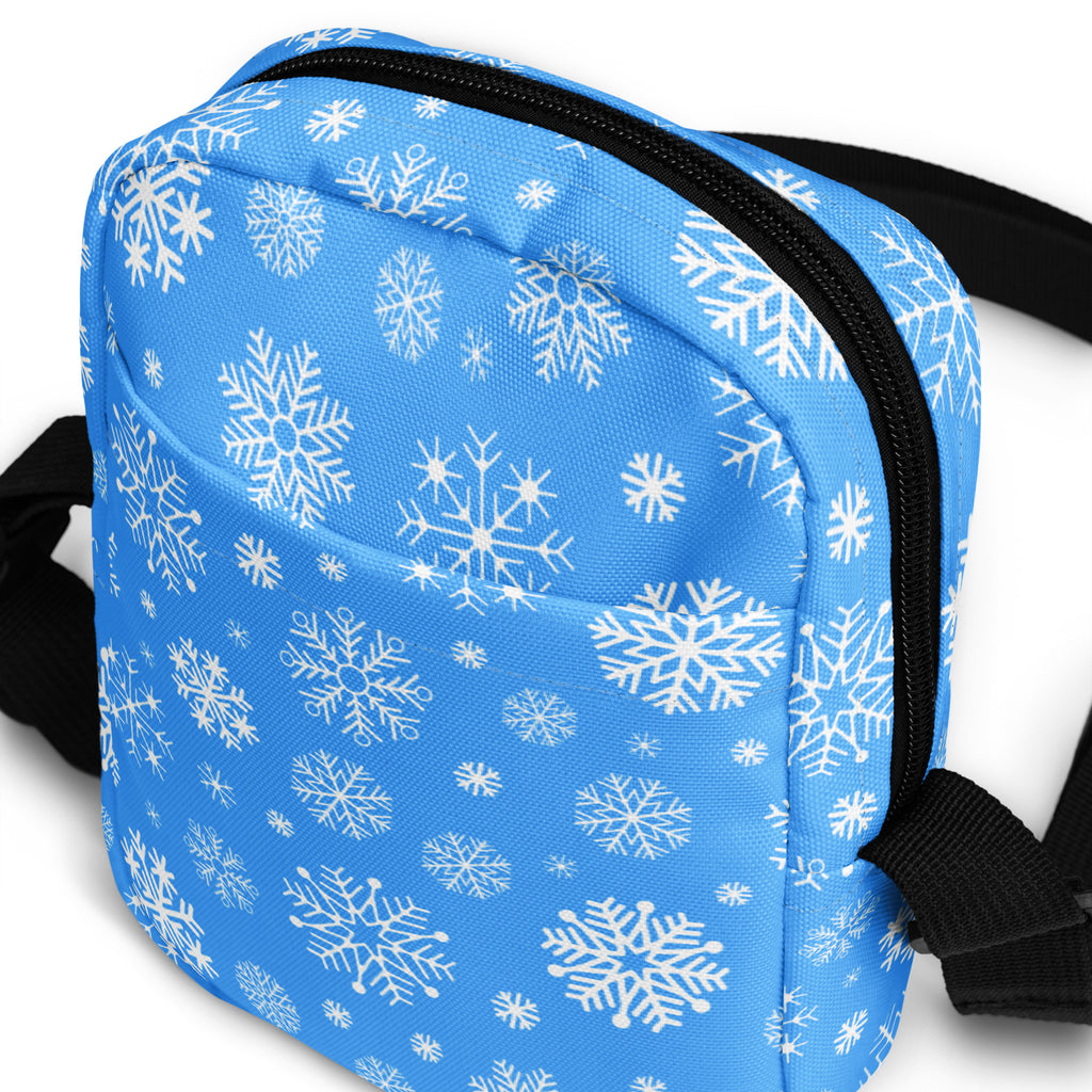 Blue snowflake winter women crossbody purse with black zipper and straps featuring a snowflake pattern