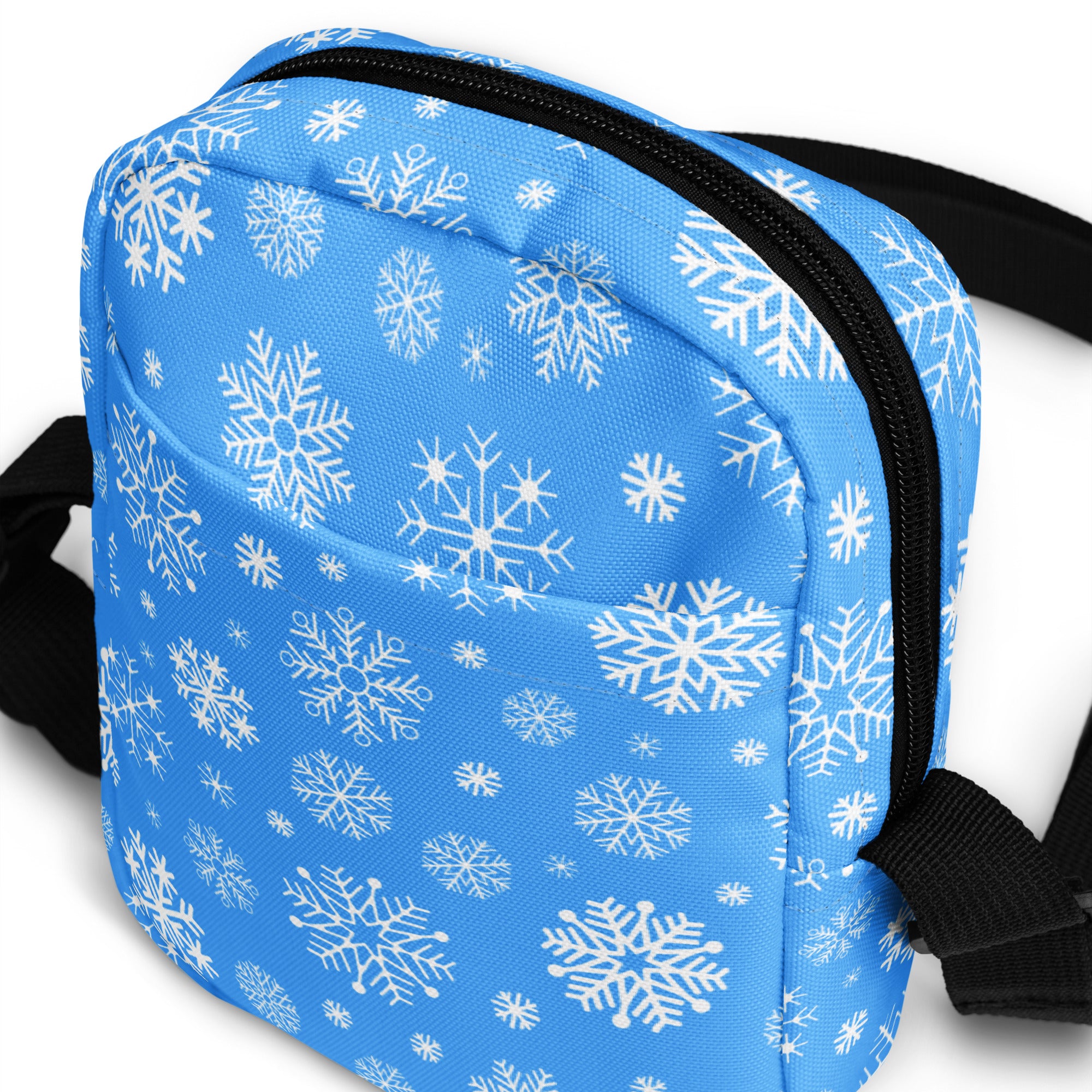 Blue snowflake winter women crossbody purse with black zipper and straps featuring a snowflake pattern