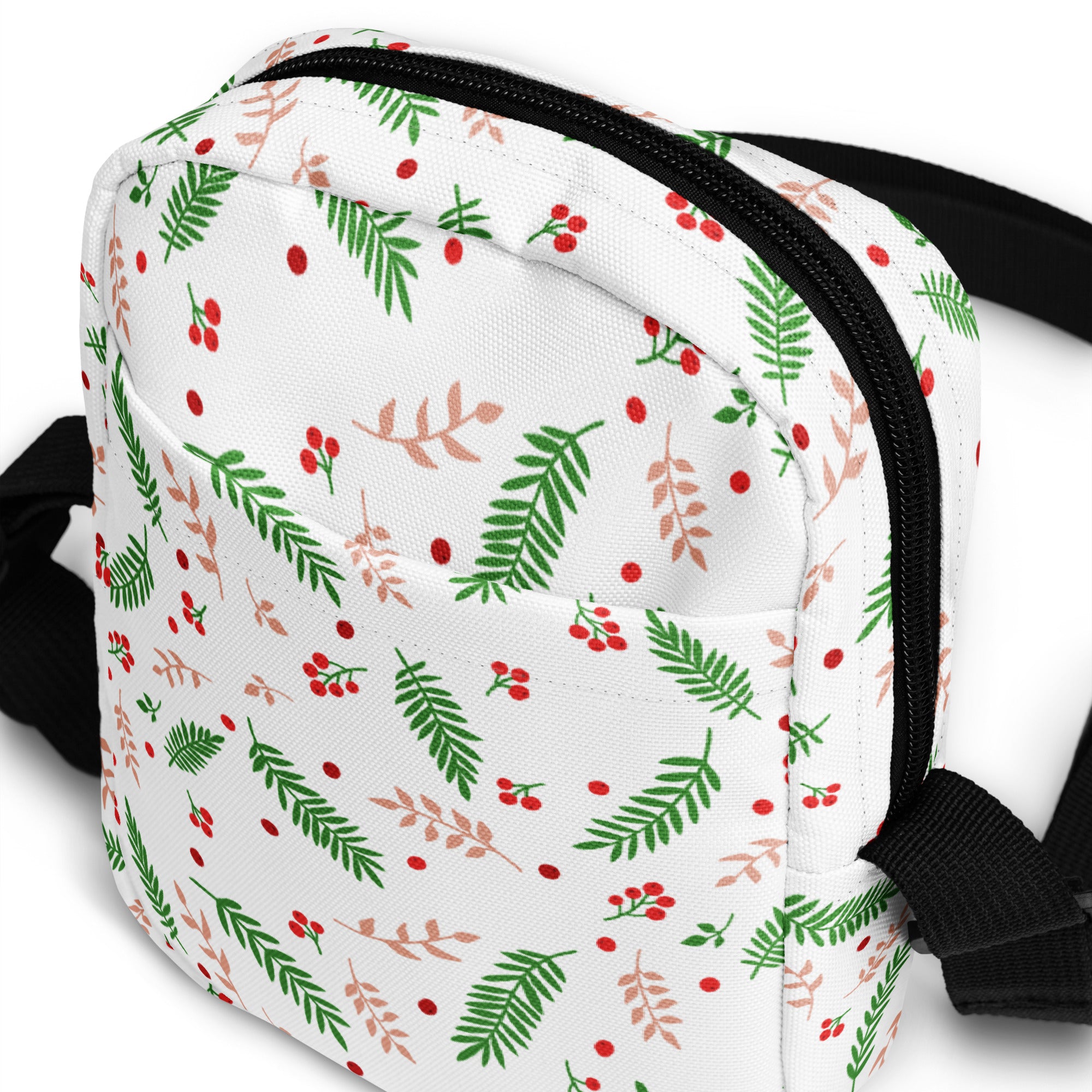 White winter fern and berry christmas women’s crossbody purse with green and blush pink leaf pattern and black zipper trim