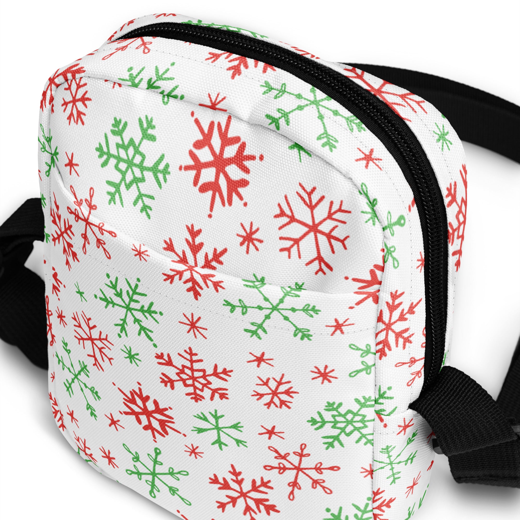 Girls red and green snowflakes crossbody purse in white fabric with festive pattern black zipper trim and adjustable strap