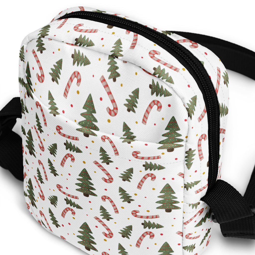 White canvas girls crossbody bag with festive green pine trees and red and white striped candy canes pattern