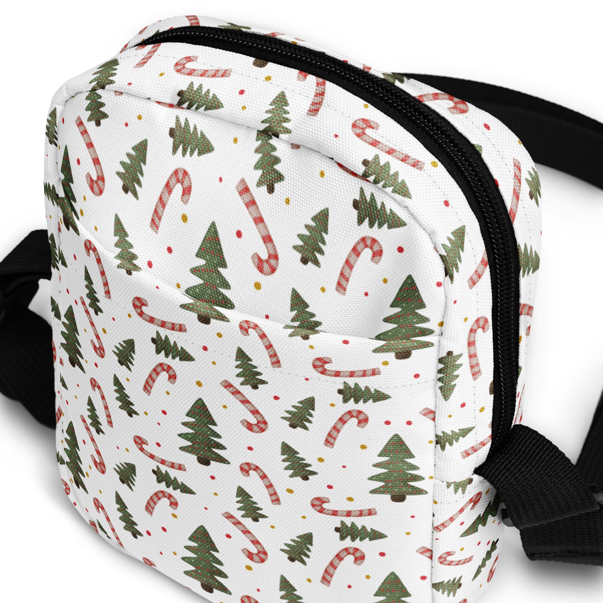 White canvas girls crossbody bag with festive green pine trees and red and white striped candy canes pattern