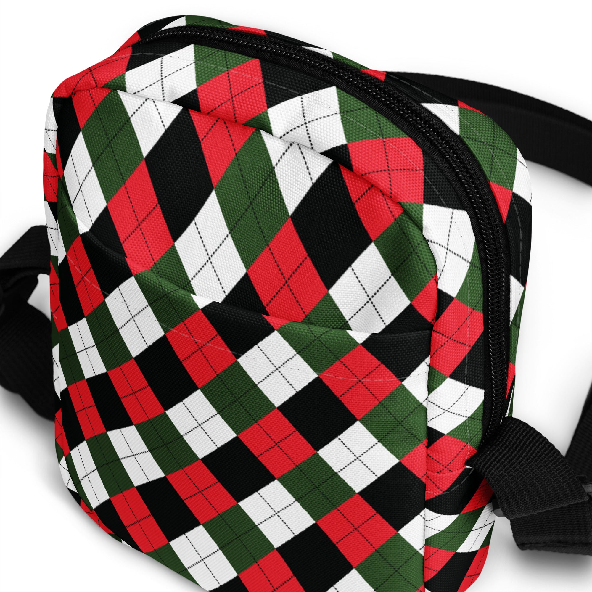 A girls christmas argyle crossbody purse in red green and black with a quilted texture and festive pattern
