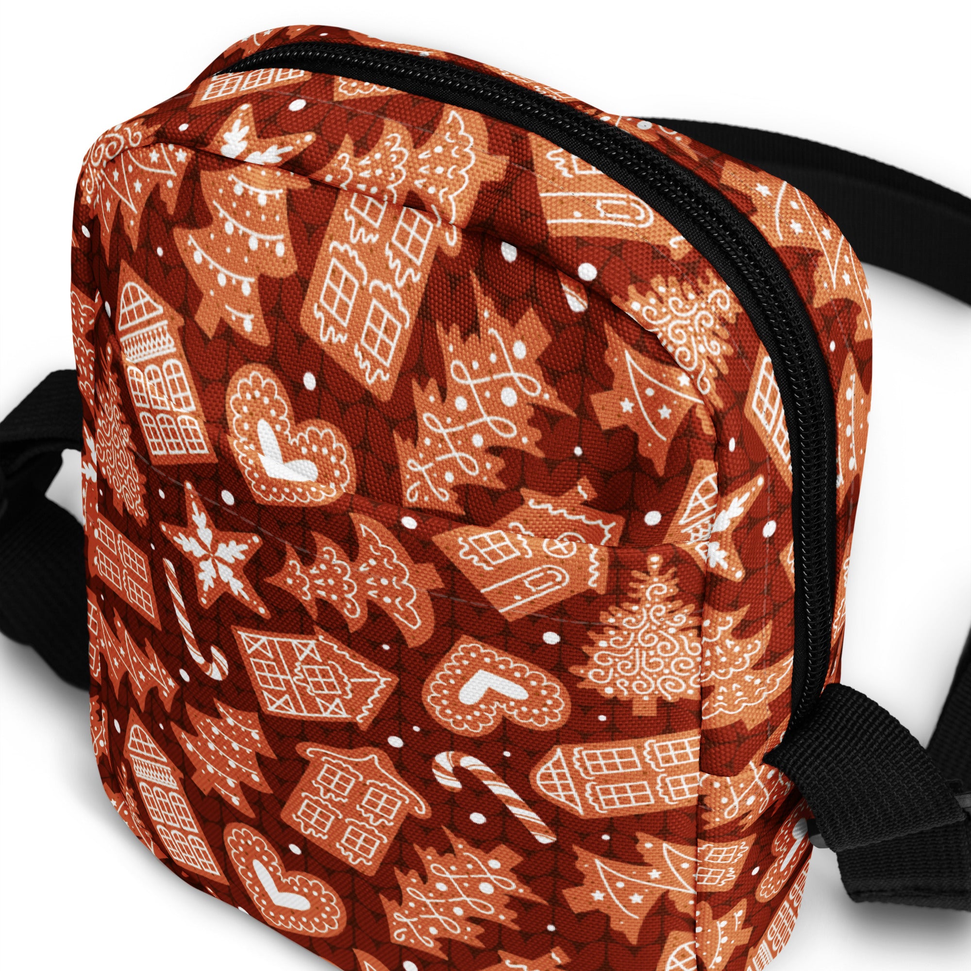 A festive brown fabric fanny pack with white gingerbread houses candy canes and snowflakes pattern for Christmas