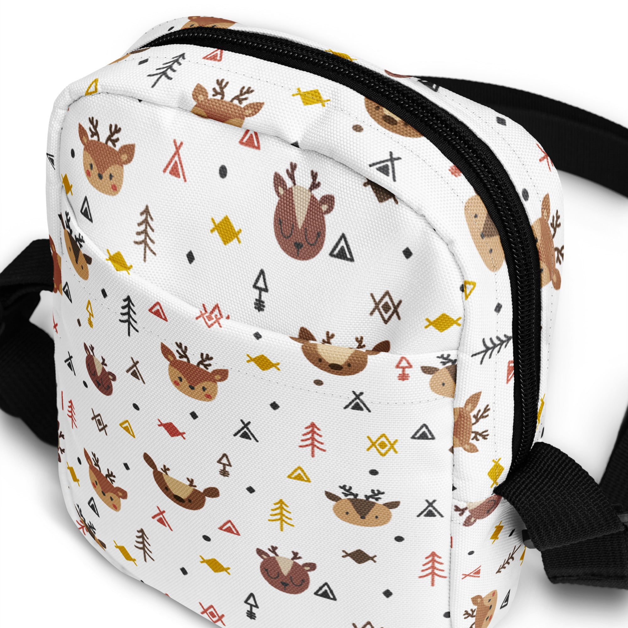 White canvas reindeer christmas women’s crossbody purse with playful brown deer faces yellow fish and geometric shapes