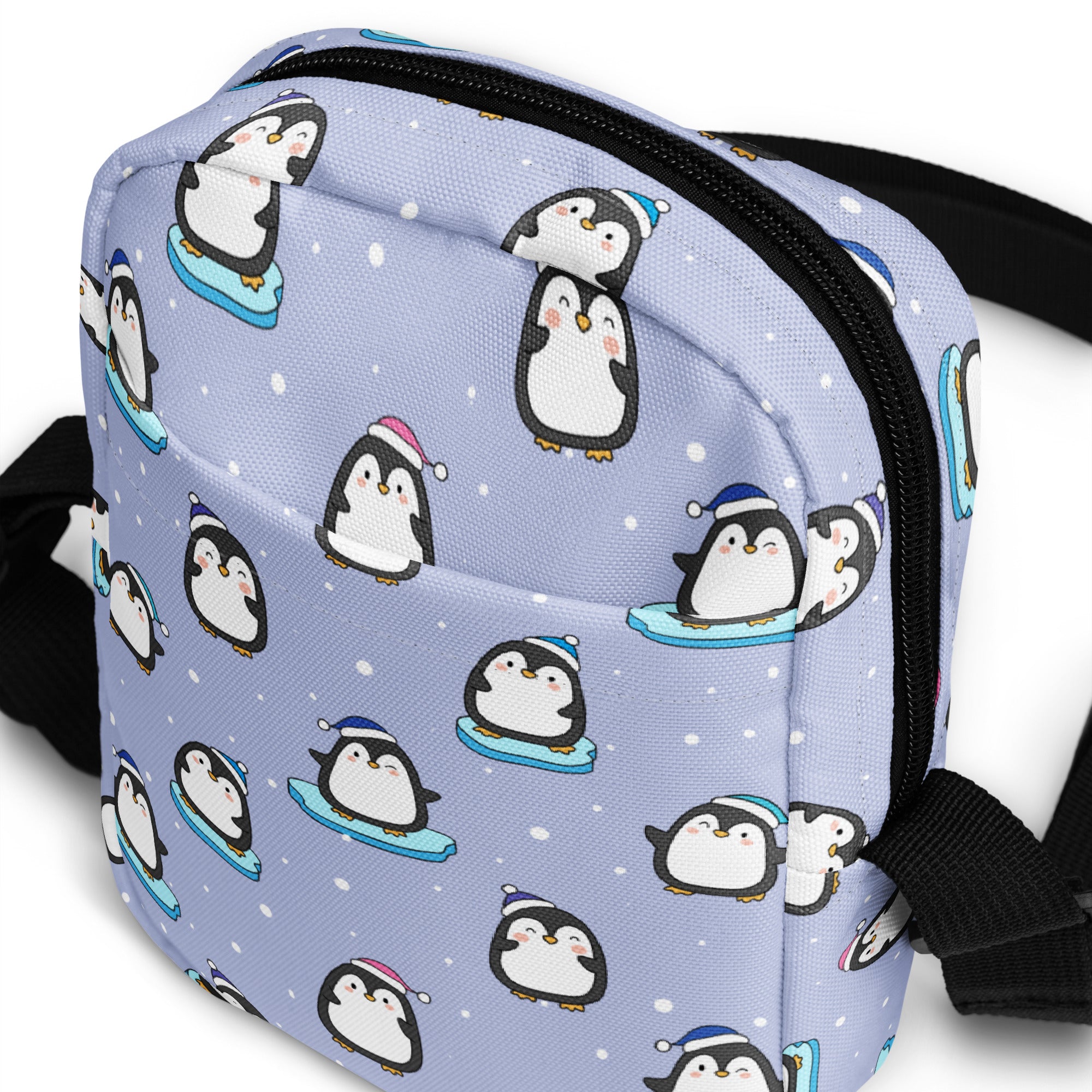 Light purple penguin-themed women’s crossbody purse with black zipper and straps for cute winter use
