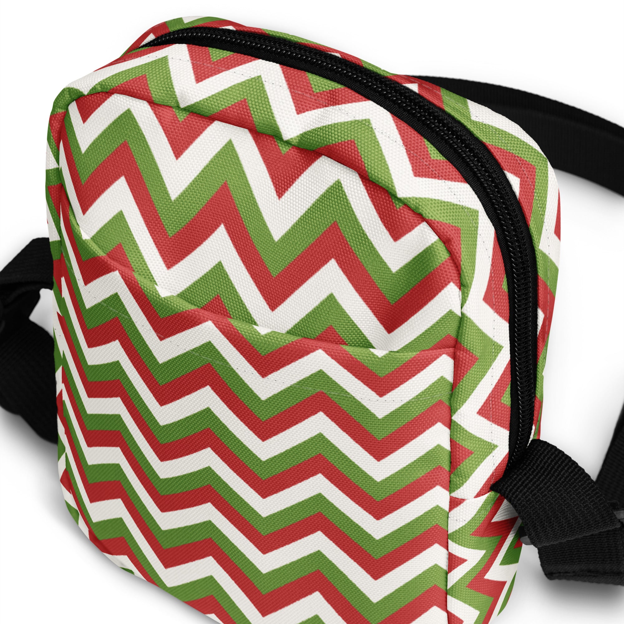 Christmas chevron women’s canvas crossbody purse with festive red green and white zigzag pattern and black zipper strap