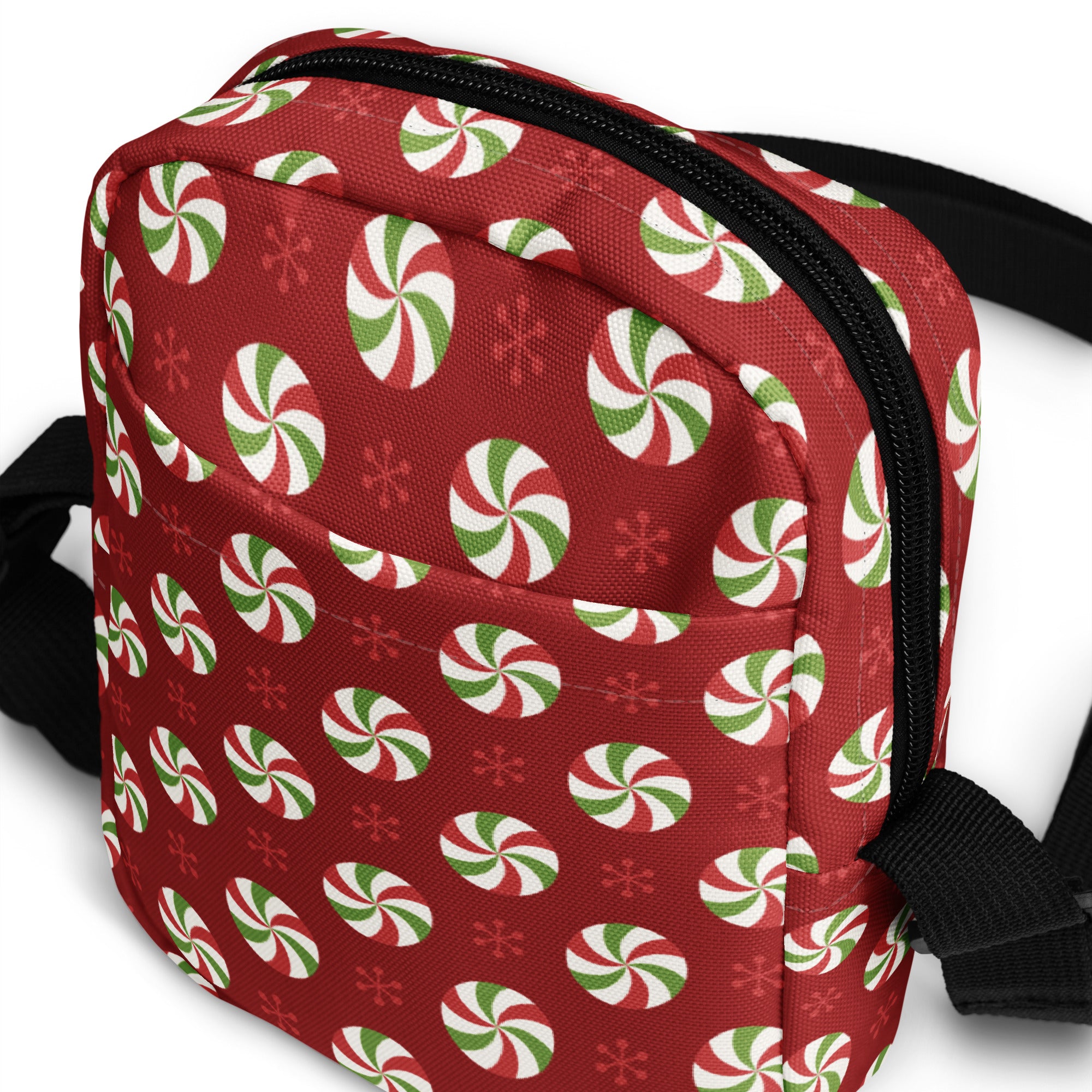 Red crossbody bag with festive green white and red peppermint candy and snowflake pattern for christmas use