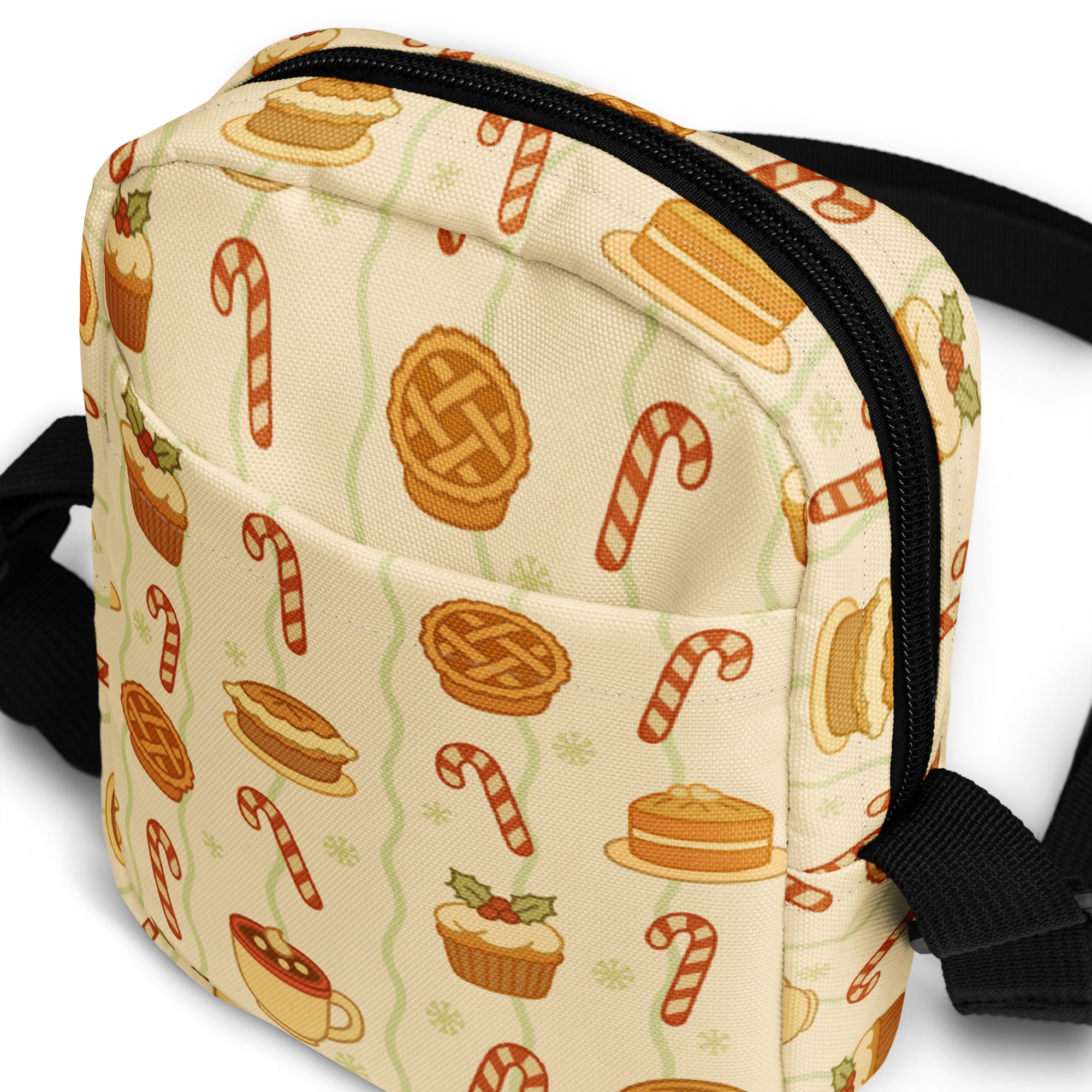 Cream-colored fabric crossbody bag with festive candy cane pie cupcake and hot cocoa pattern in warm tones