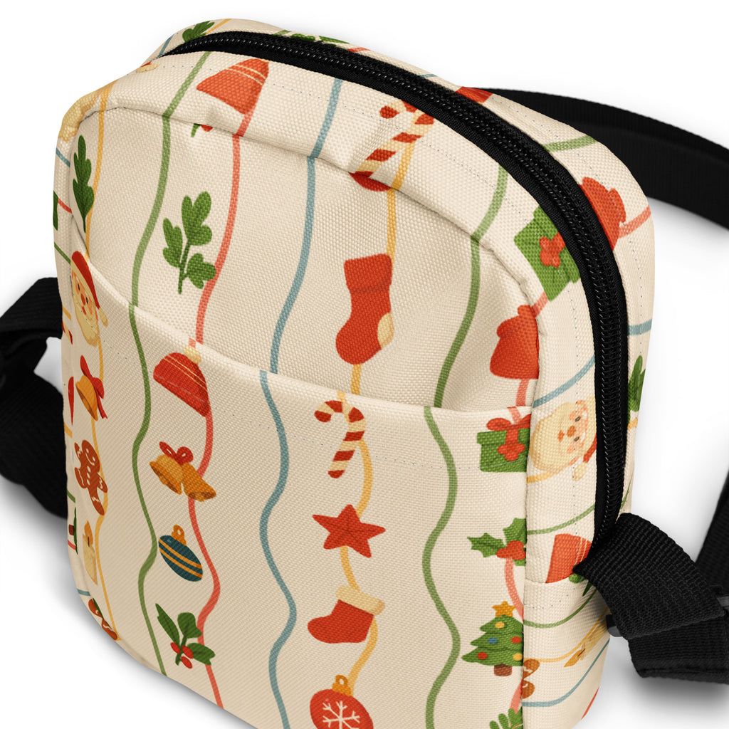 A festive cream-colored canvas crossbody bag with christmas stockings candy canes and ornaments pattern