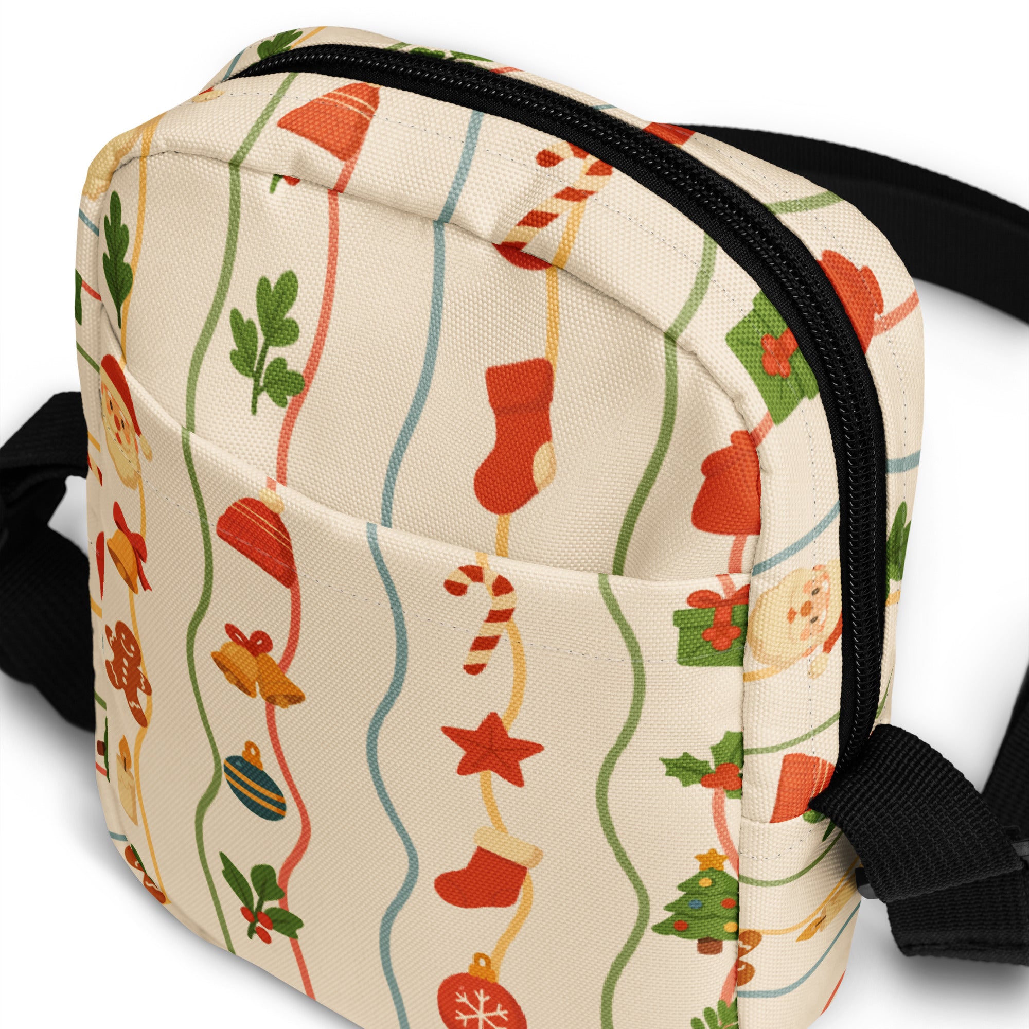 A festive cream-colored canvas crossbody bag with christmas stockings candy canes and ornaments pattern