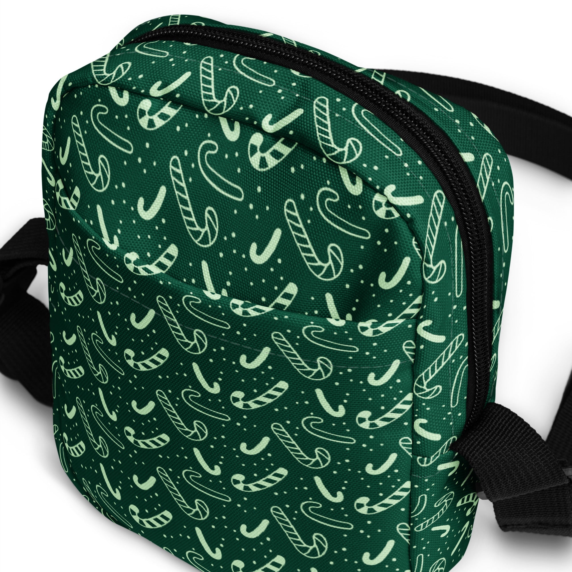 Green candy cane Christmas women’s crossbody purse with dark green fabric white candy cane pattern and black zipper trim