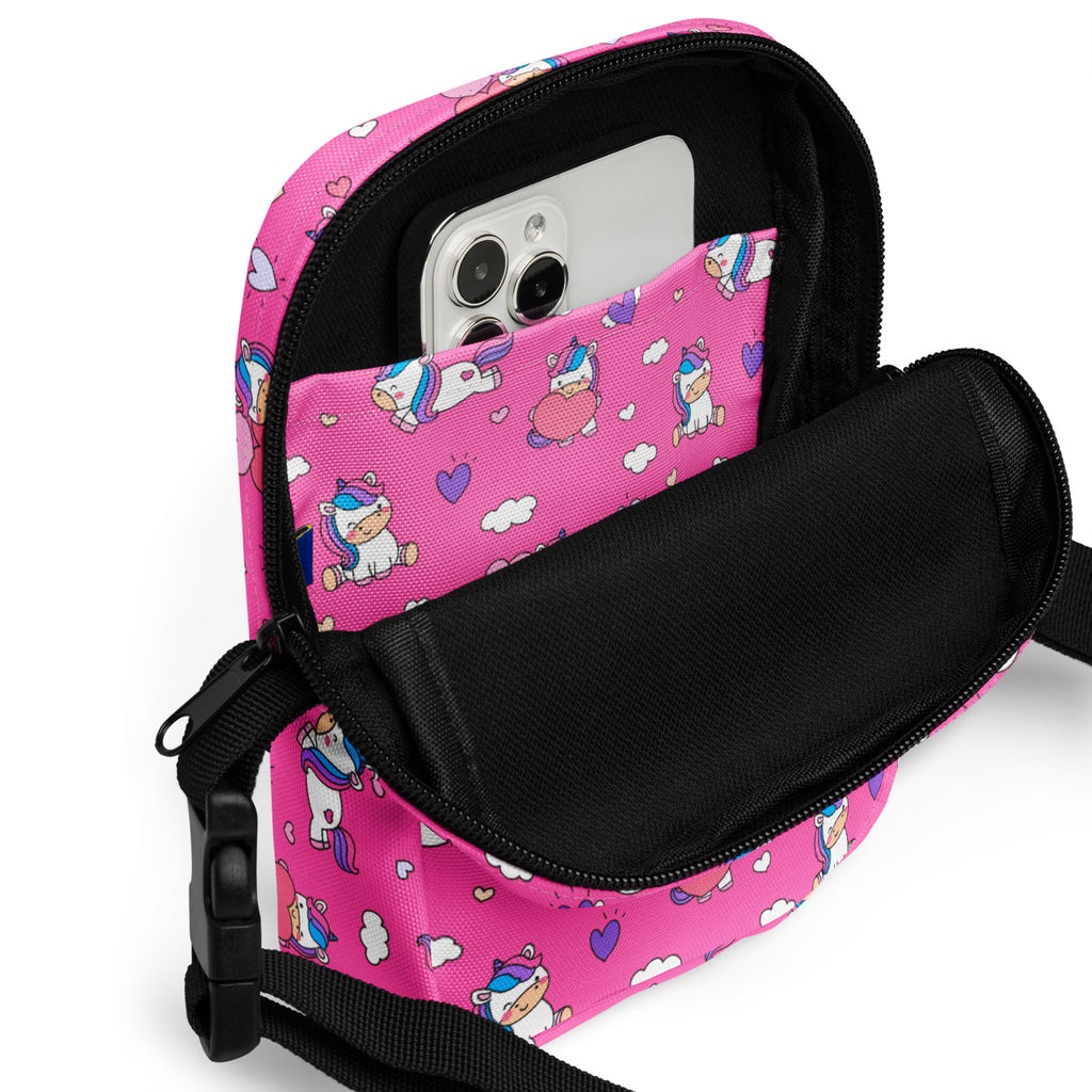 Girls pink unicorns crossbody purse with a pink unicorn-patterned fabric, black zipper, and adjustable strap