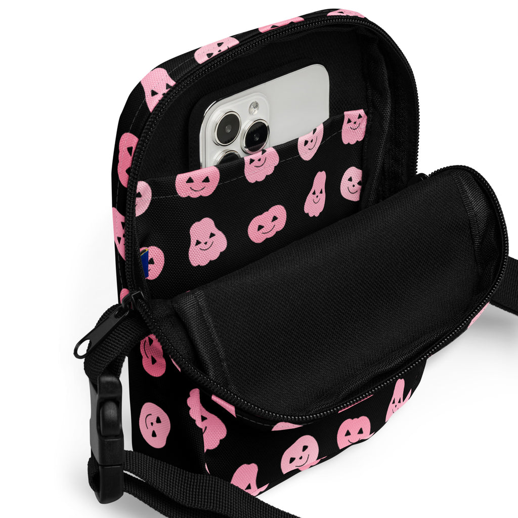 Black crossbody phone pouch with pink smiling pumpkin and ghost patterns for girls halloween use