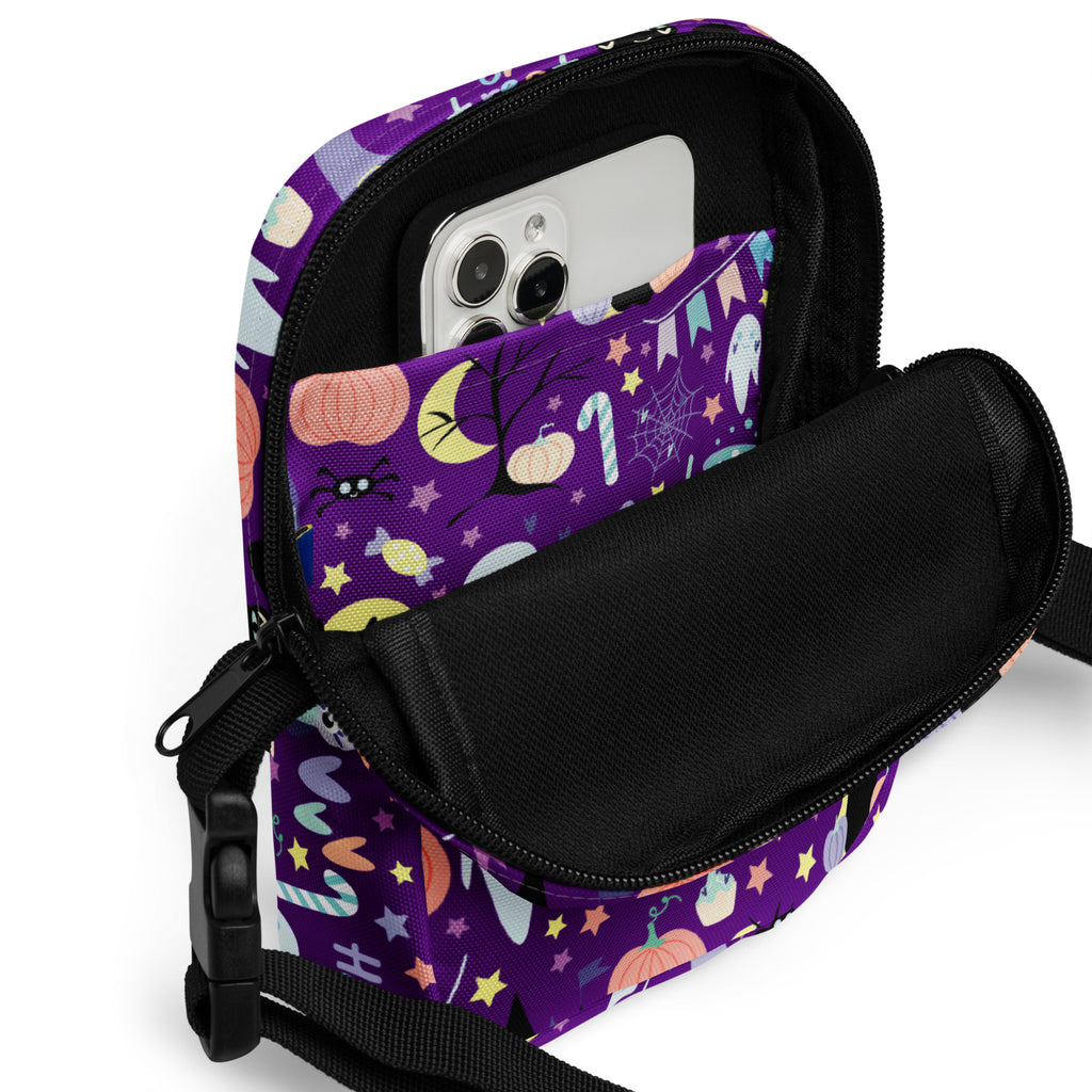 Girls spooky halloween crossbody purse in purple fabric with playful pumpkin bat and star pattern