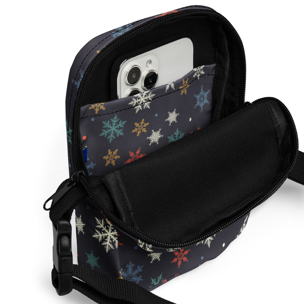 Black crossbody phone pouch with colorful snowflake pattern and black zipper for women’s crossbody purse