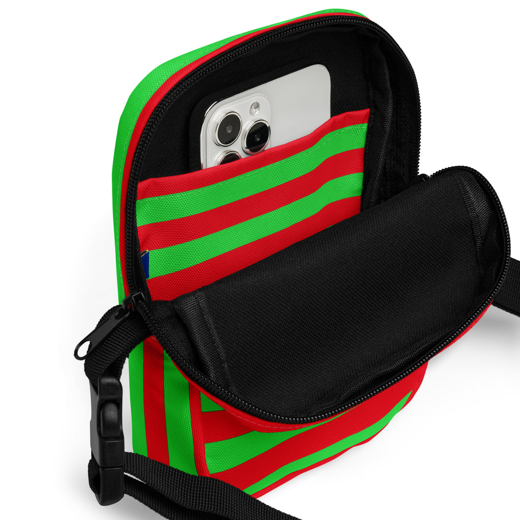 Red and green striped Christmas women’s crossbody purse with black interior, zipper closure, and adjustable strap