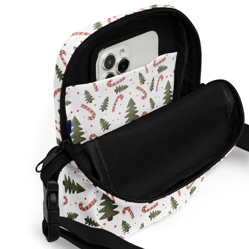 White christmas-themed crossbody purse with green pine trees red candy canes fabric surface black lining adjustable strap
