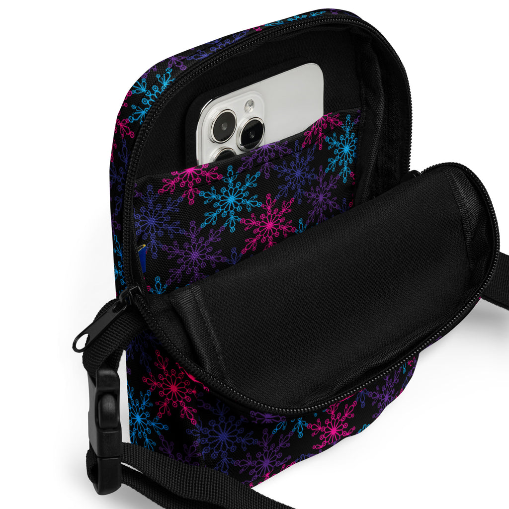 Girls neon snowflakes crossbody purse in black with vibrant pink blue and purple snowflake pattern for everyday use