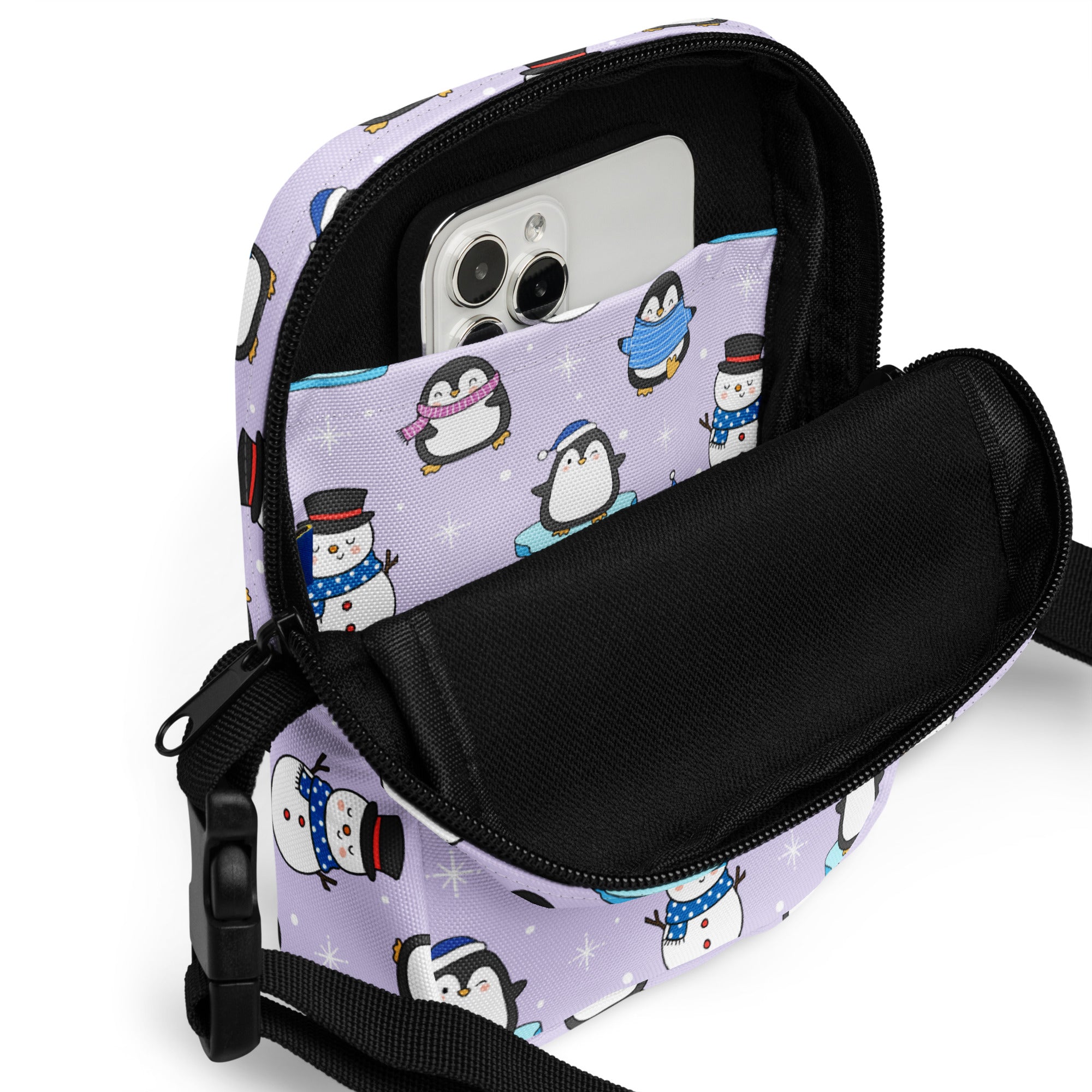 Holiday penguins and snowmen women’s crossbody purse with lavender penguin and snowman pattern and black zipper accents