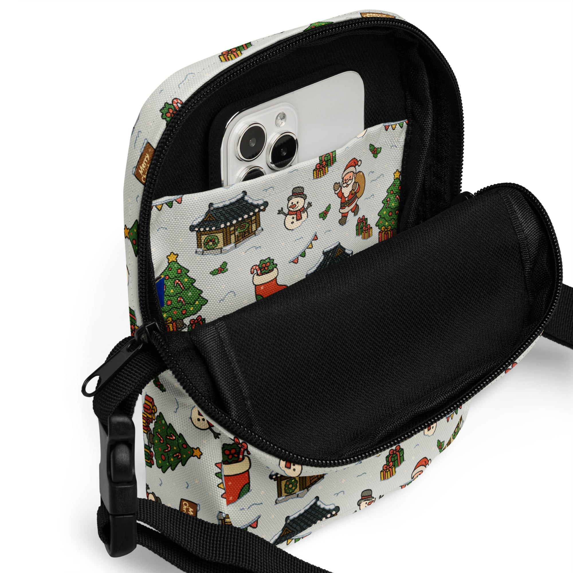 White christmas village women’s crossbody purse with festive santa snowmen and tree illustrations on light fabric