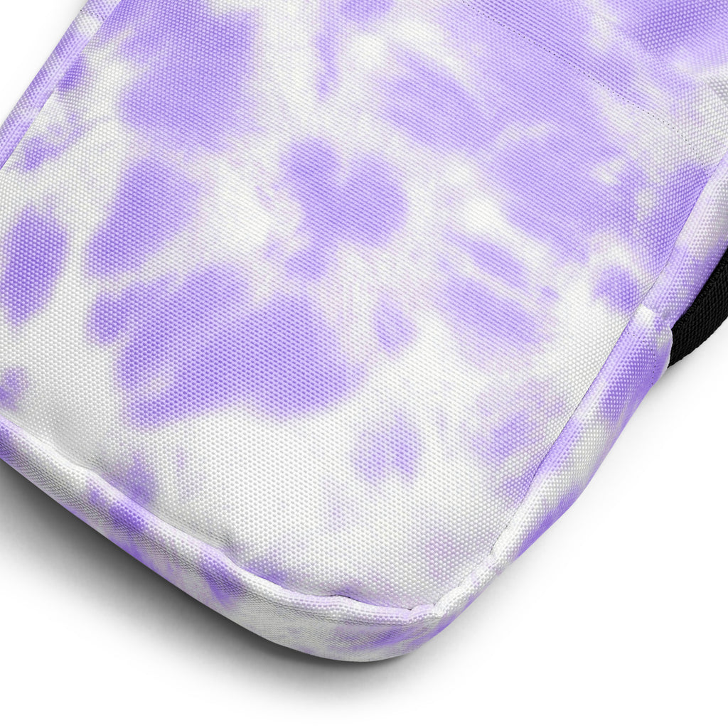 Girls faux purple tie dye crossbody purse featuring a purple and white tie-dye fabric pouch with a textured weave