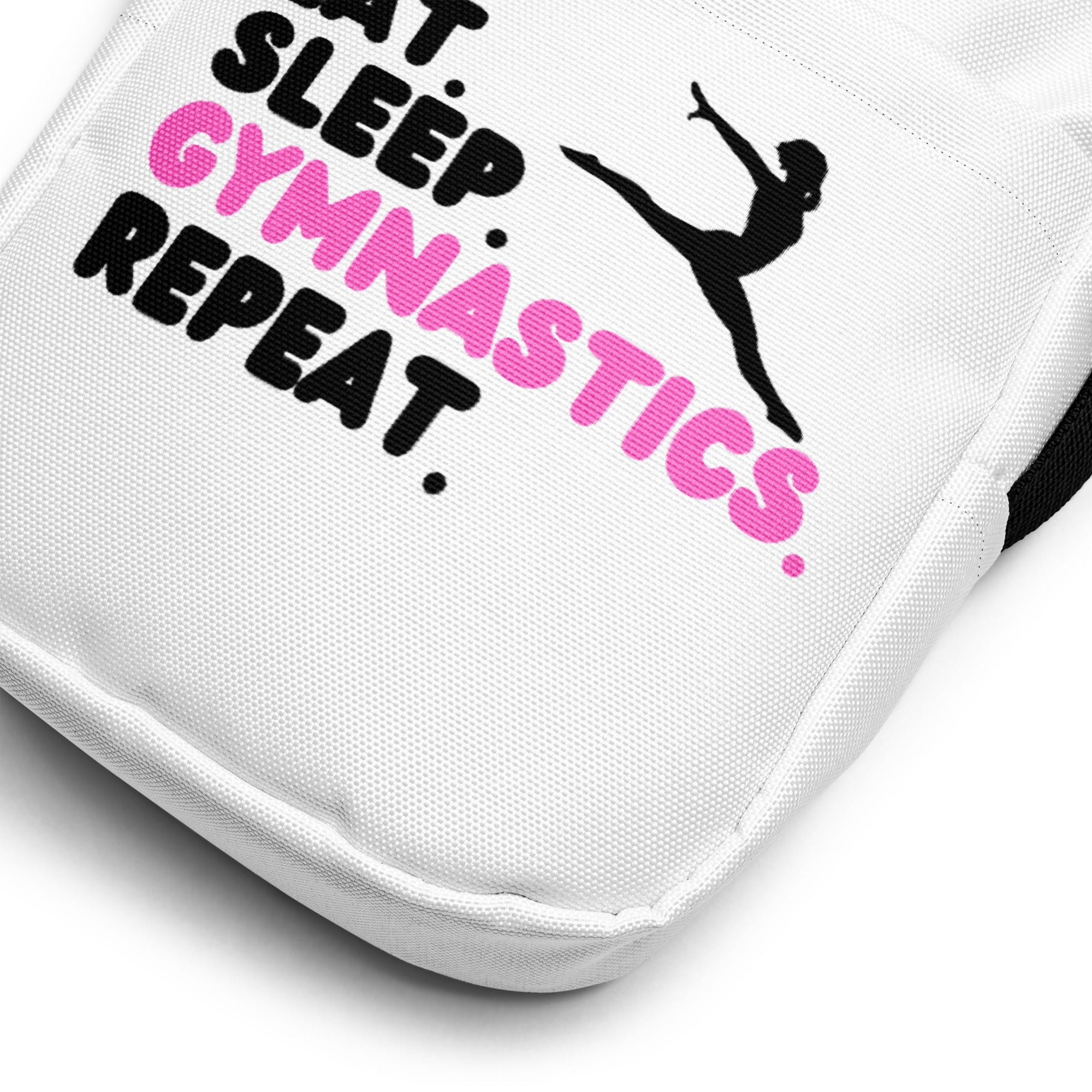 White canvas crossbody bag with black and pink embroidered eat sleep gymnastics repeat design and gymnast silhouette