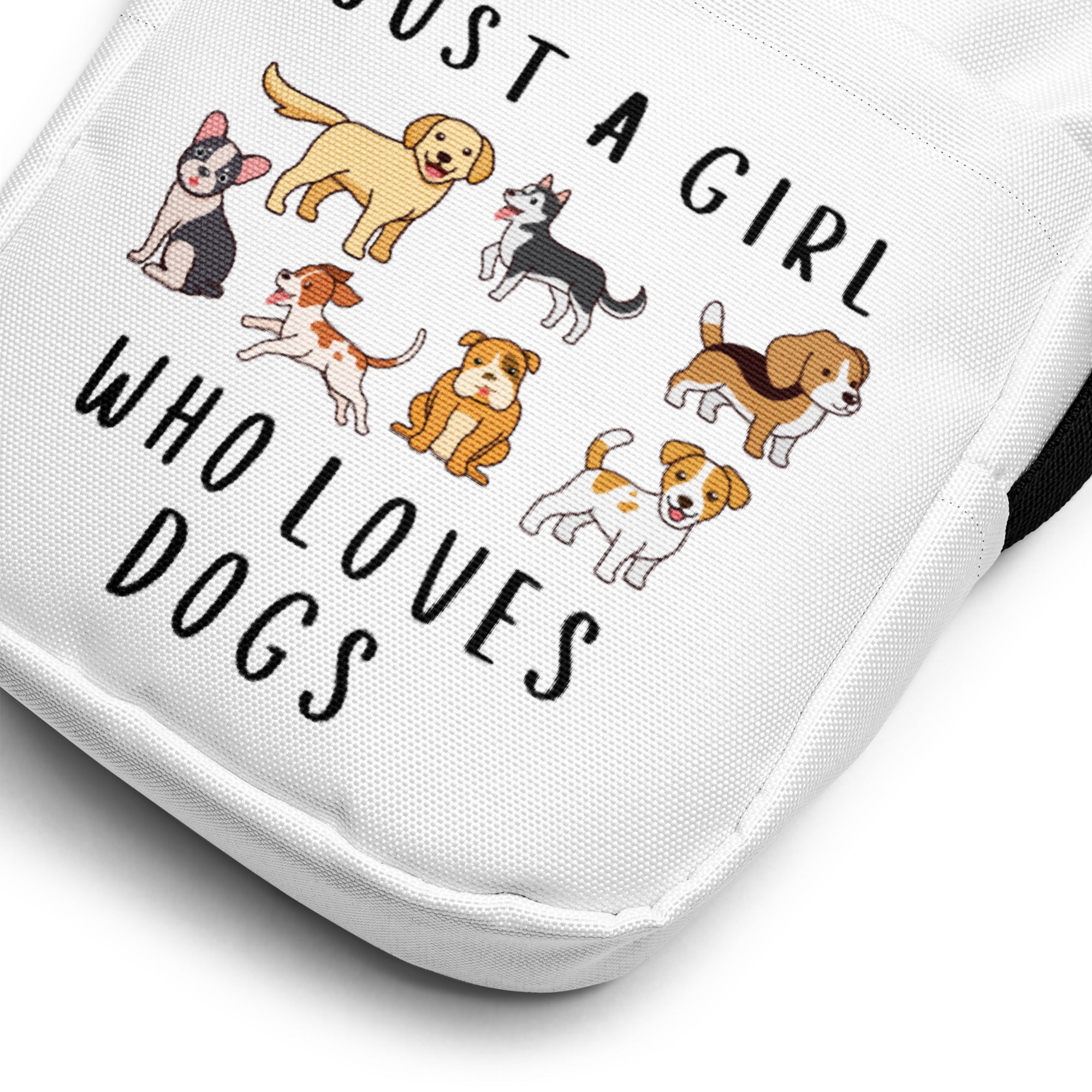 White canvas crossbody bag with playful cartoon dogs and just a girl who loves dogs phrase in black lettering