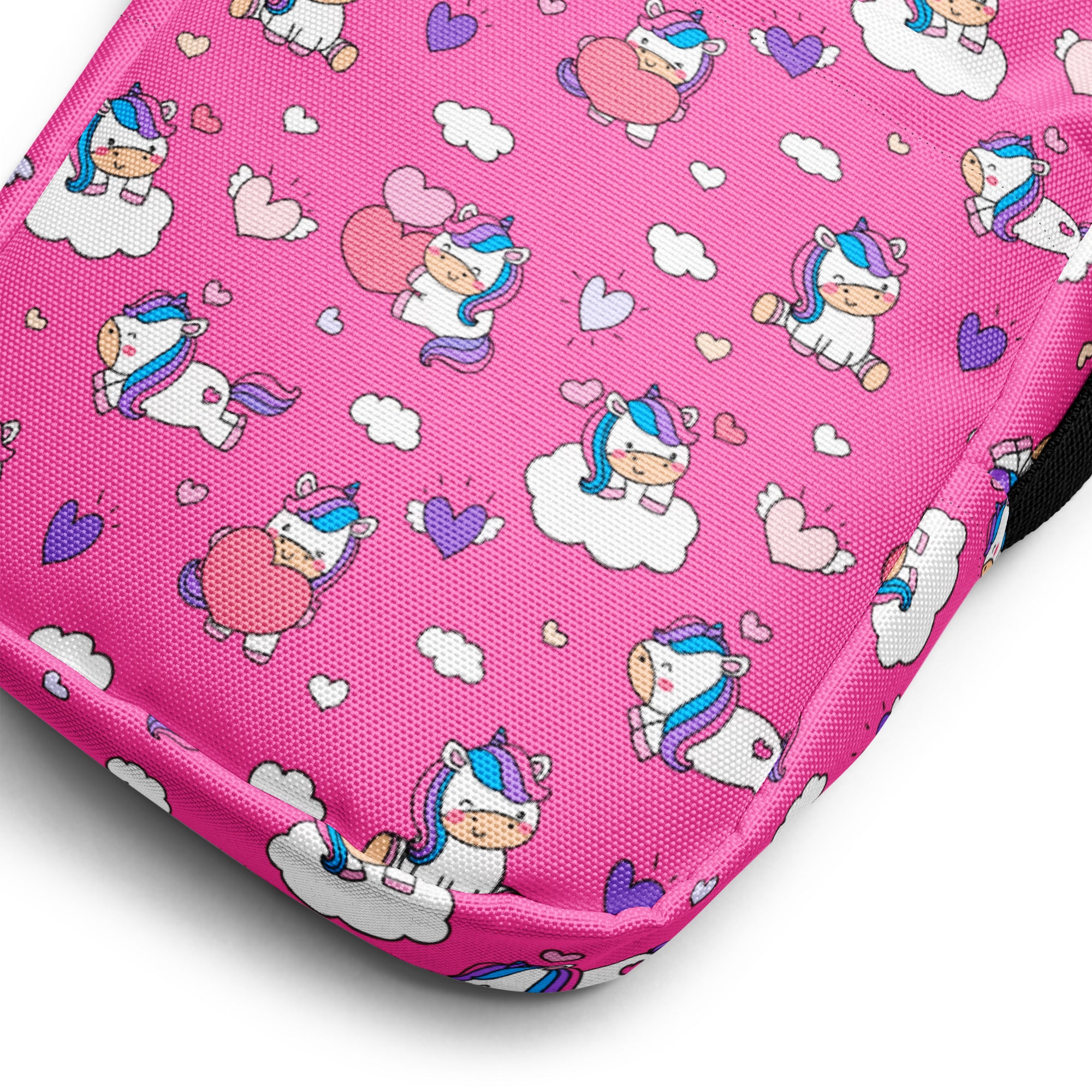 Girls pink unicorns crossbody purse made of fabric with playful cartoon unicorns on clouds and hearts pattern