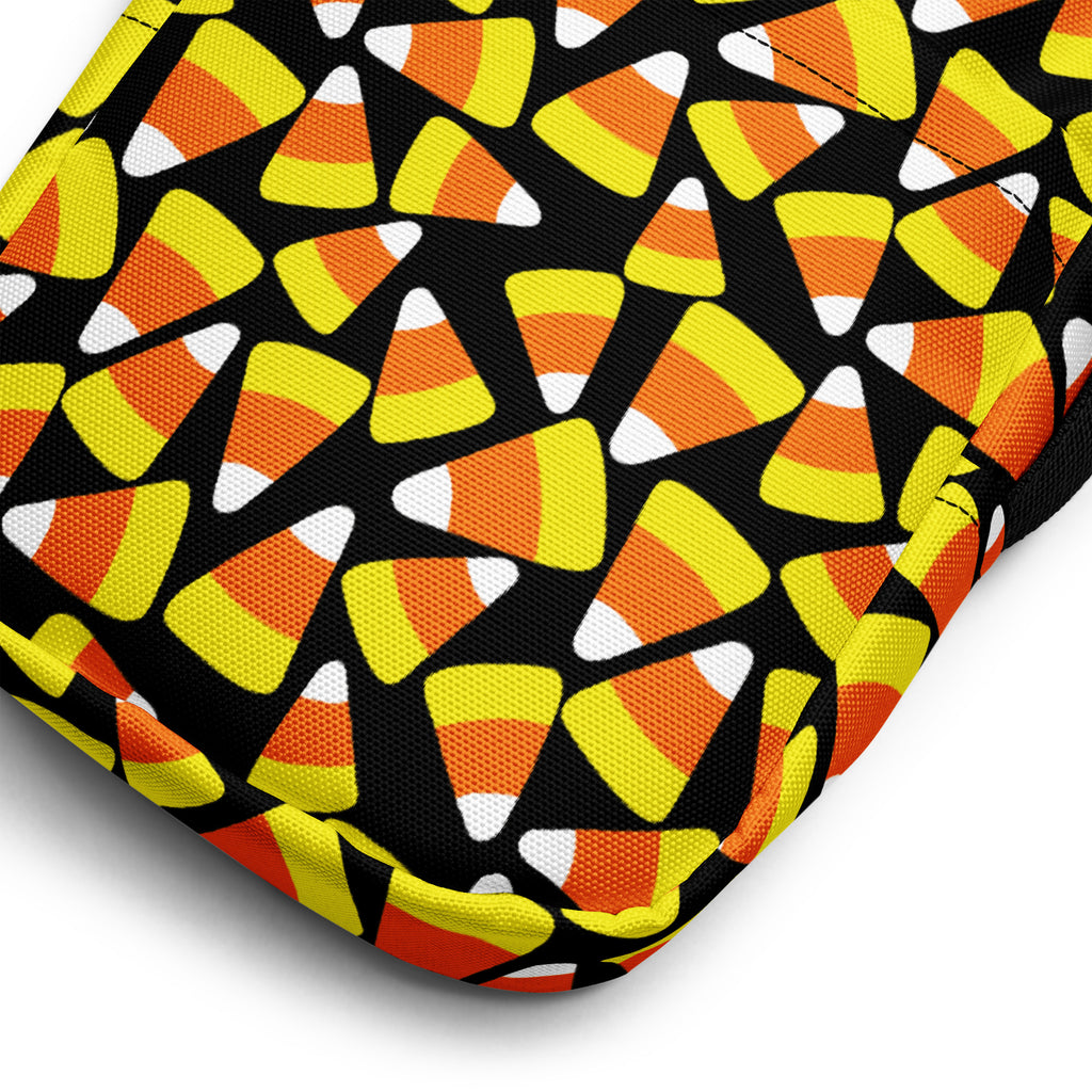 Black fabric girls candy corn halloween crossbody purse with vibrant orange yellow and white candy corn pattern