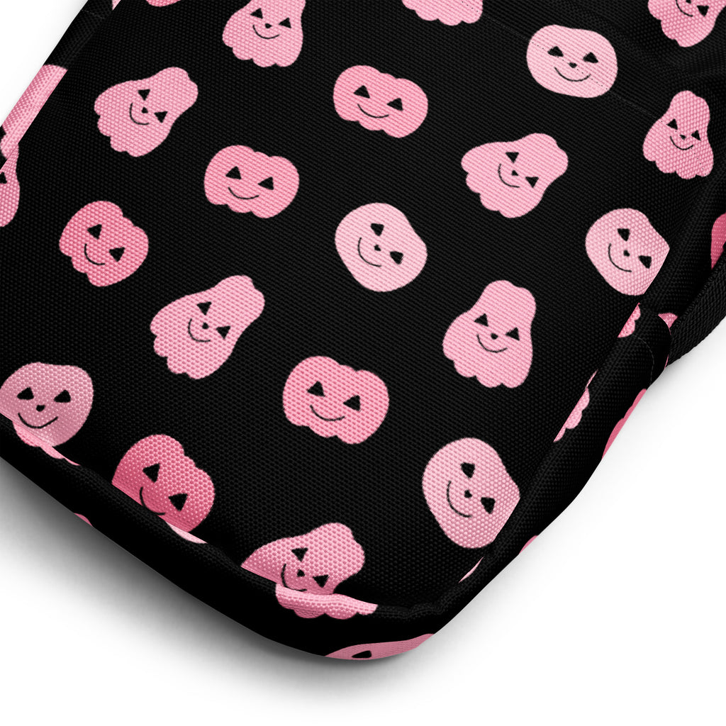 Black fabric girls pink pumpkins halloween crossbody purse with repeating pink smiling pumpkin and ghost pattern