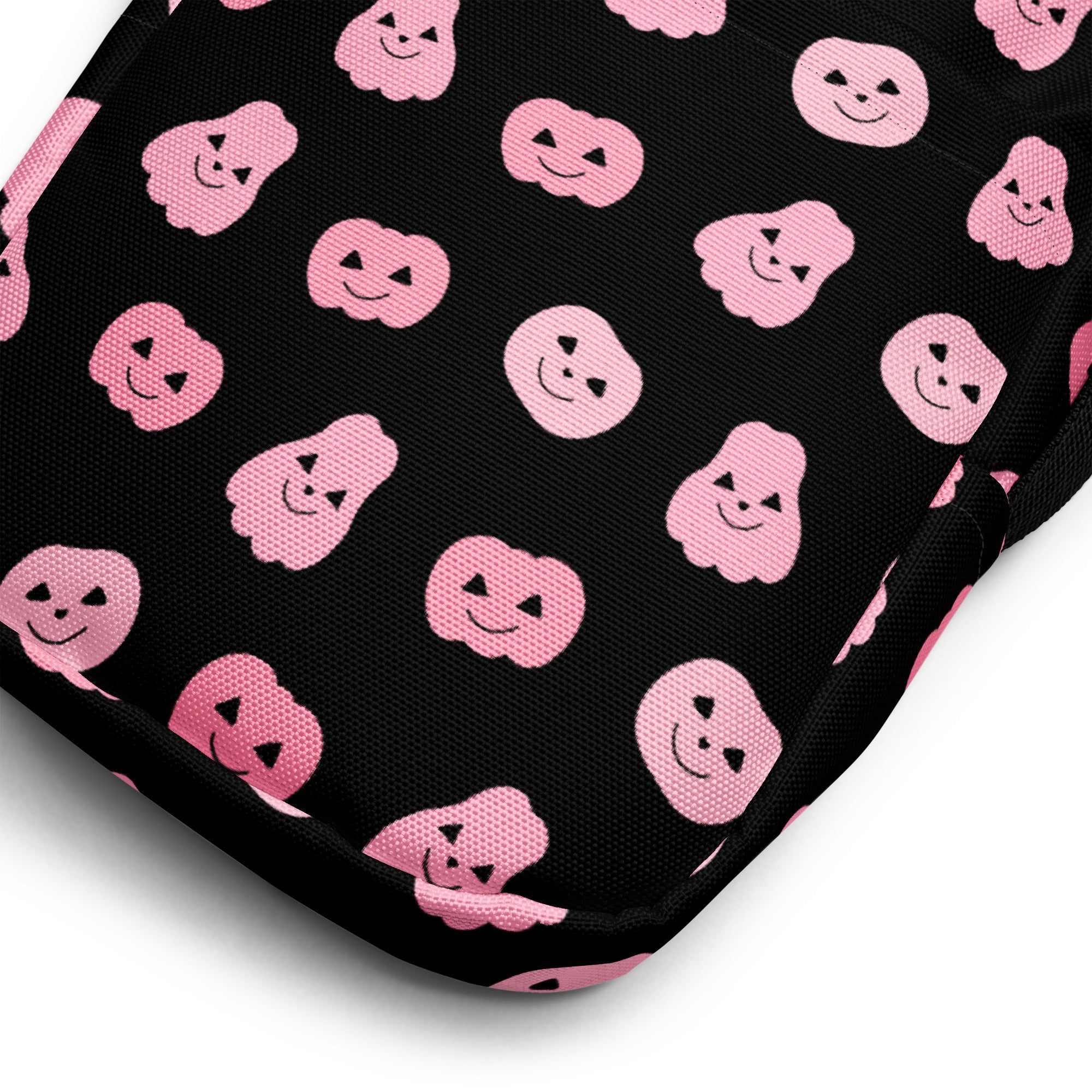Black fabric girls pink pumpkins halloween crossbody purse with repeating pink smiling pumpkin and ghost pattern