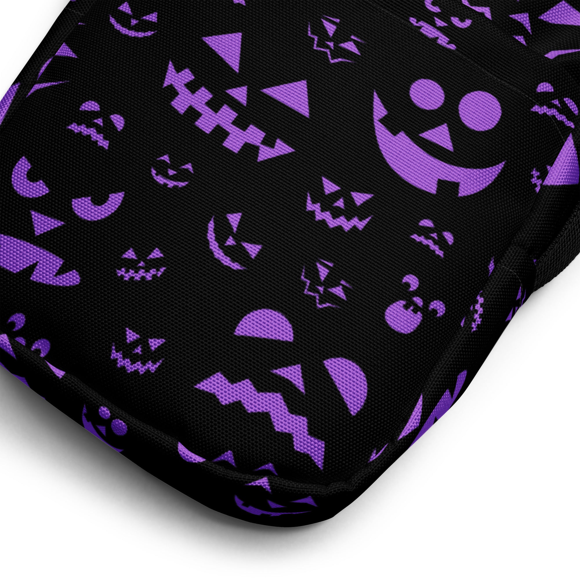 Black fabric crossbody purse with purple halloween jack-o-lantern faces for girls in various sizes and styles