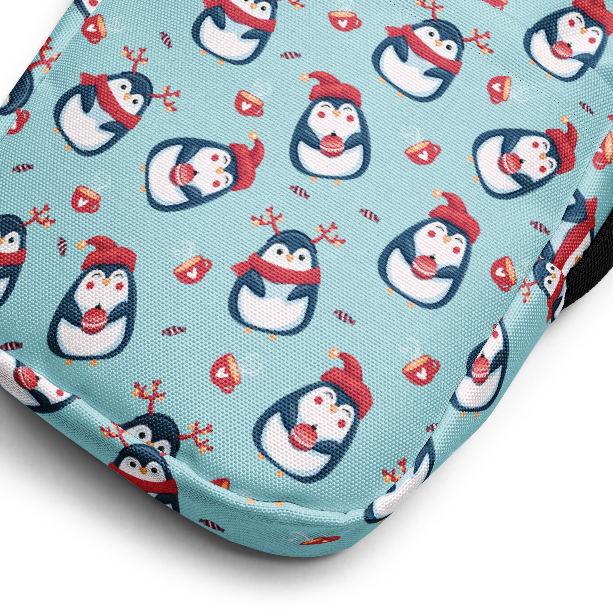 Girls reindeer penguin crossbody purse in light blue fabric with cartoon penguins wearing red hats and scarves holding candy canes