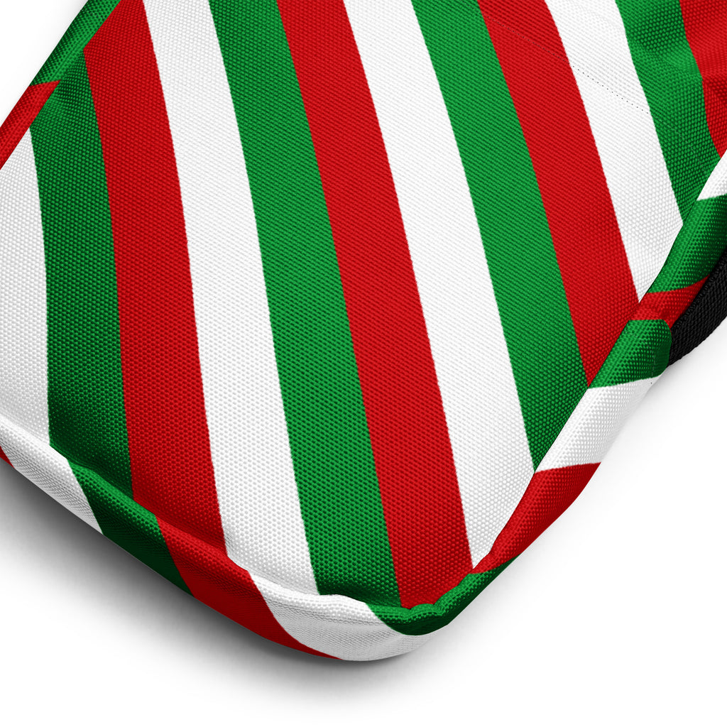 A red and green diagonal candy stripe cushion with bold fabric stripes for festive holiday decor