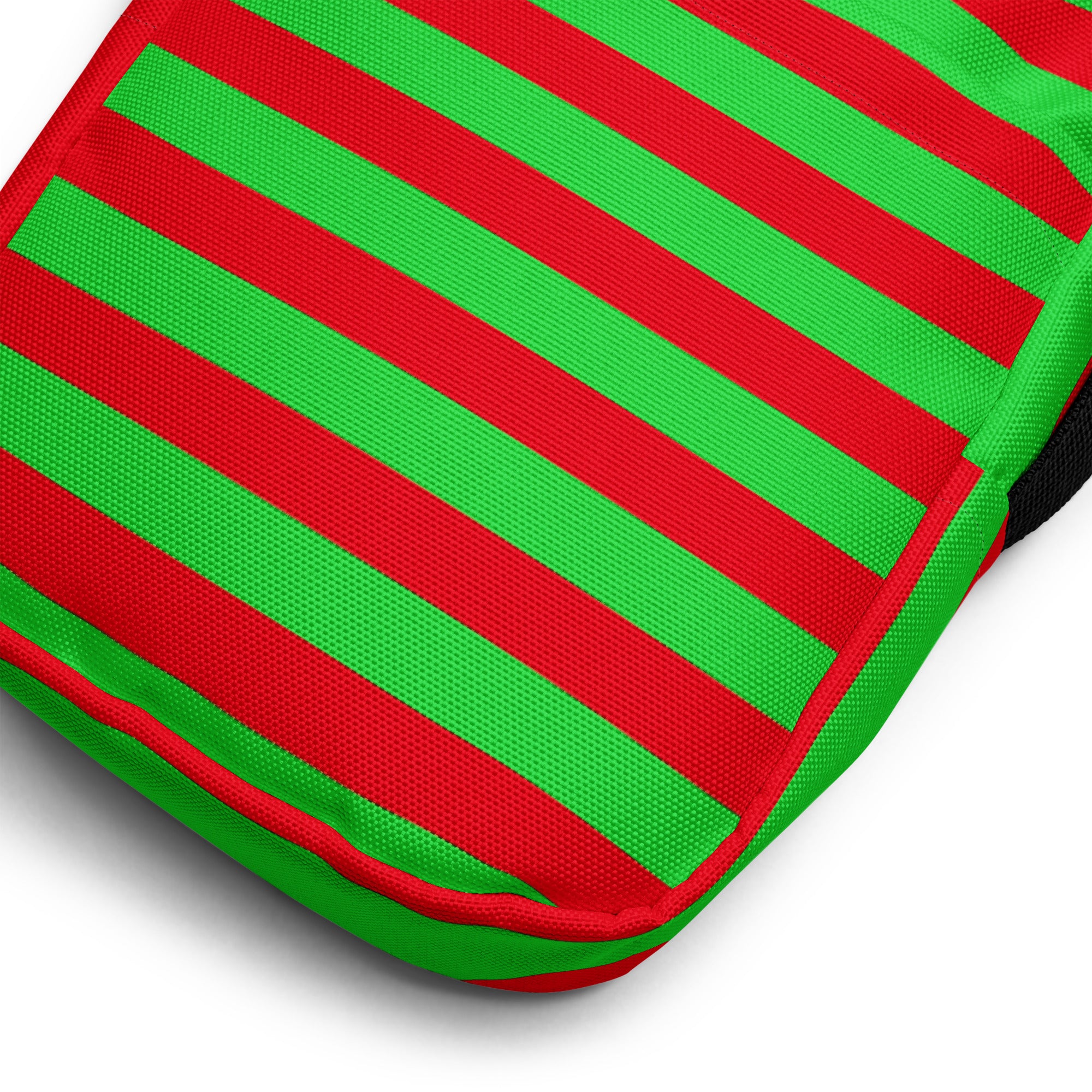 A girls red and green bold stripes Christmas crossbody purse made of vibrant textured woven fabric pouch