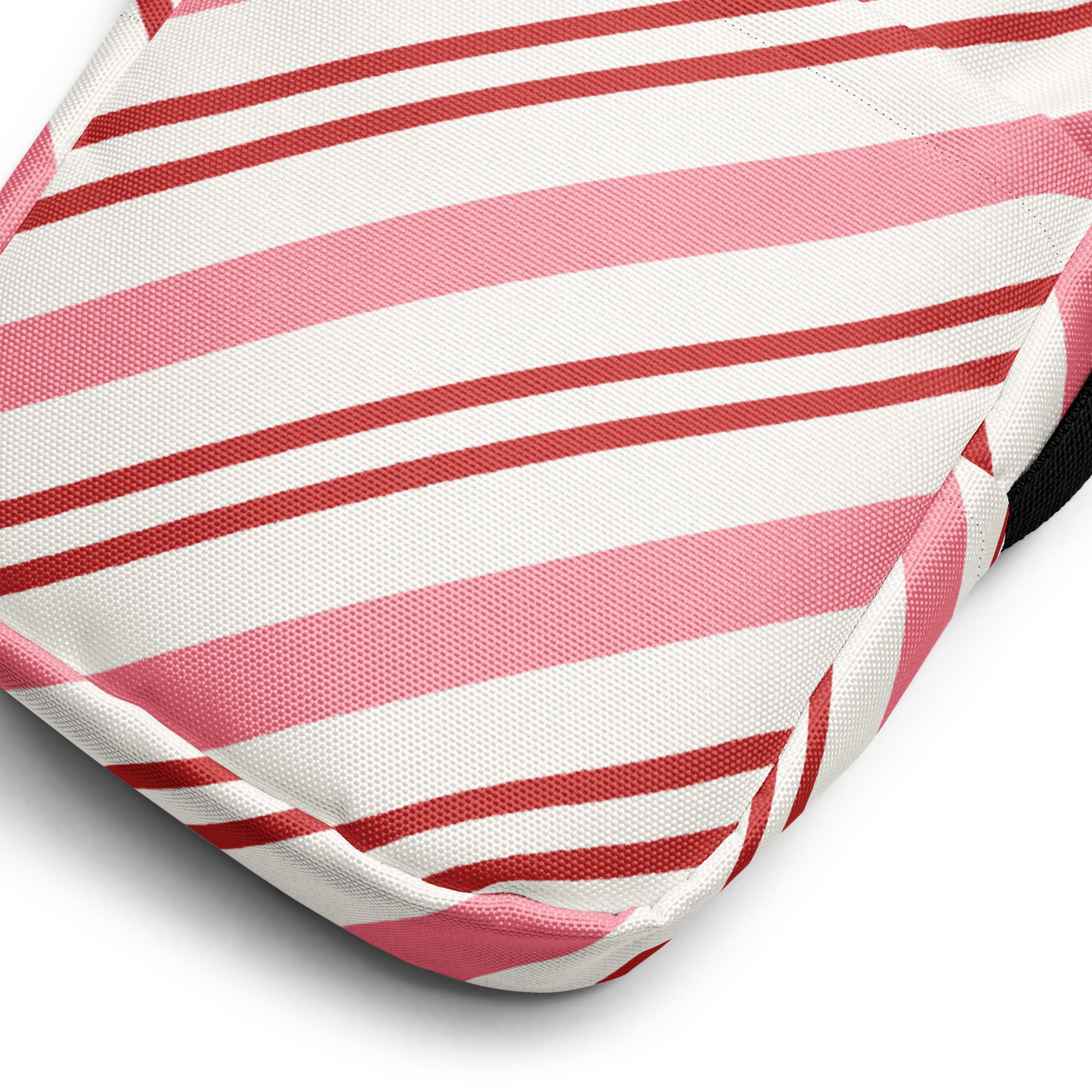 A girls pink and red candy stripe crossbody purse featuring a cushion with diagonal pink and white fabric stripes