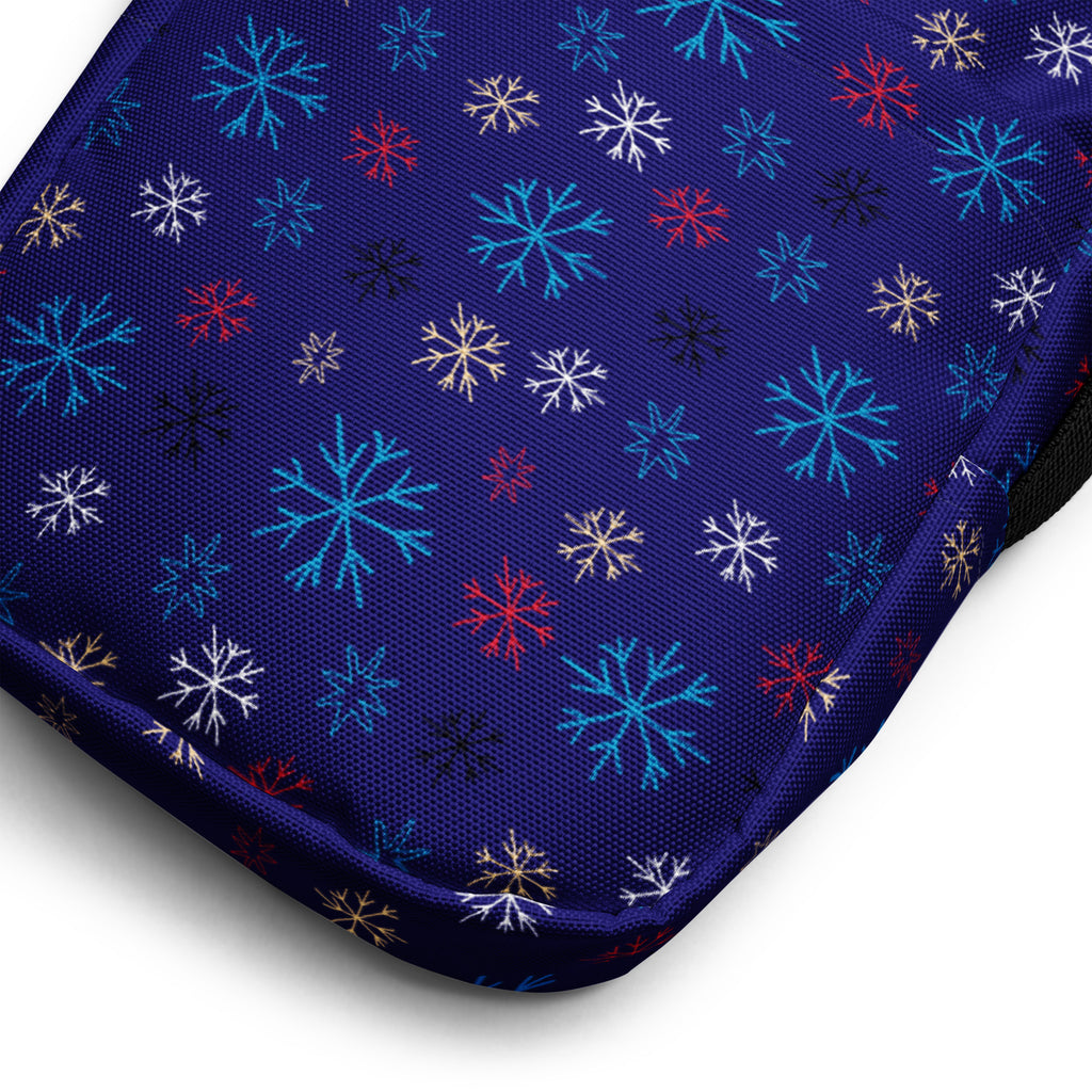 A navy blue fabric crossbody purse for girls featuring a vibrant multicolor snowflake pattern including teal red white and gold