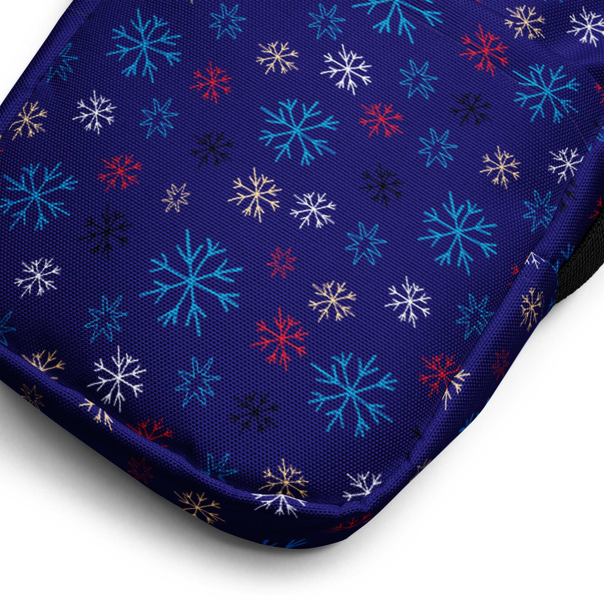 A navy blue fabric crossbody purse for girls featuring a vibrant multicolor snowflake pattern including teal red white and gold