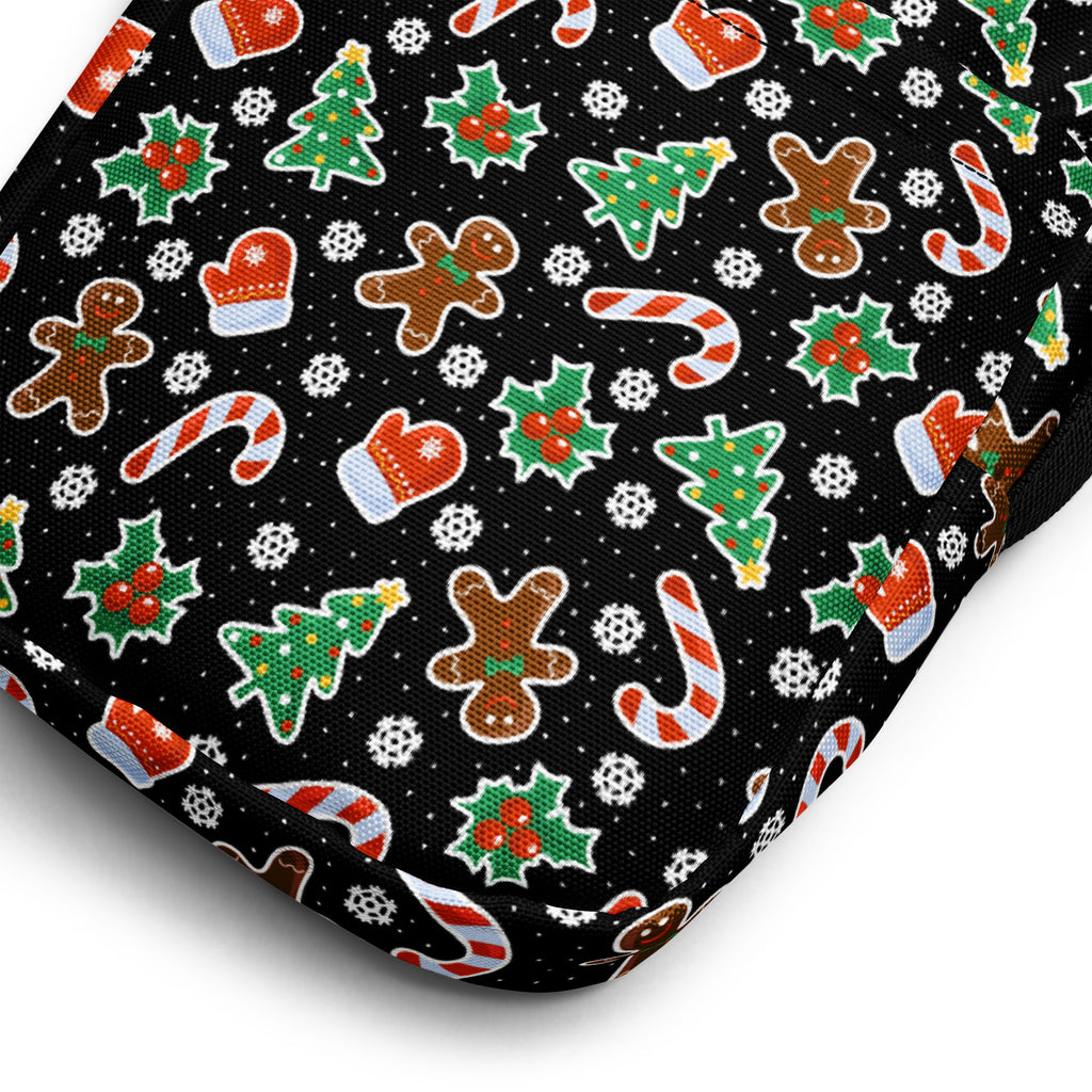 Black fabric crossbody purse for girls featuring gingerbread men candy cane and holly christmas patterns
