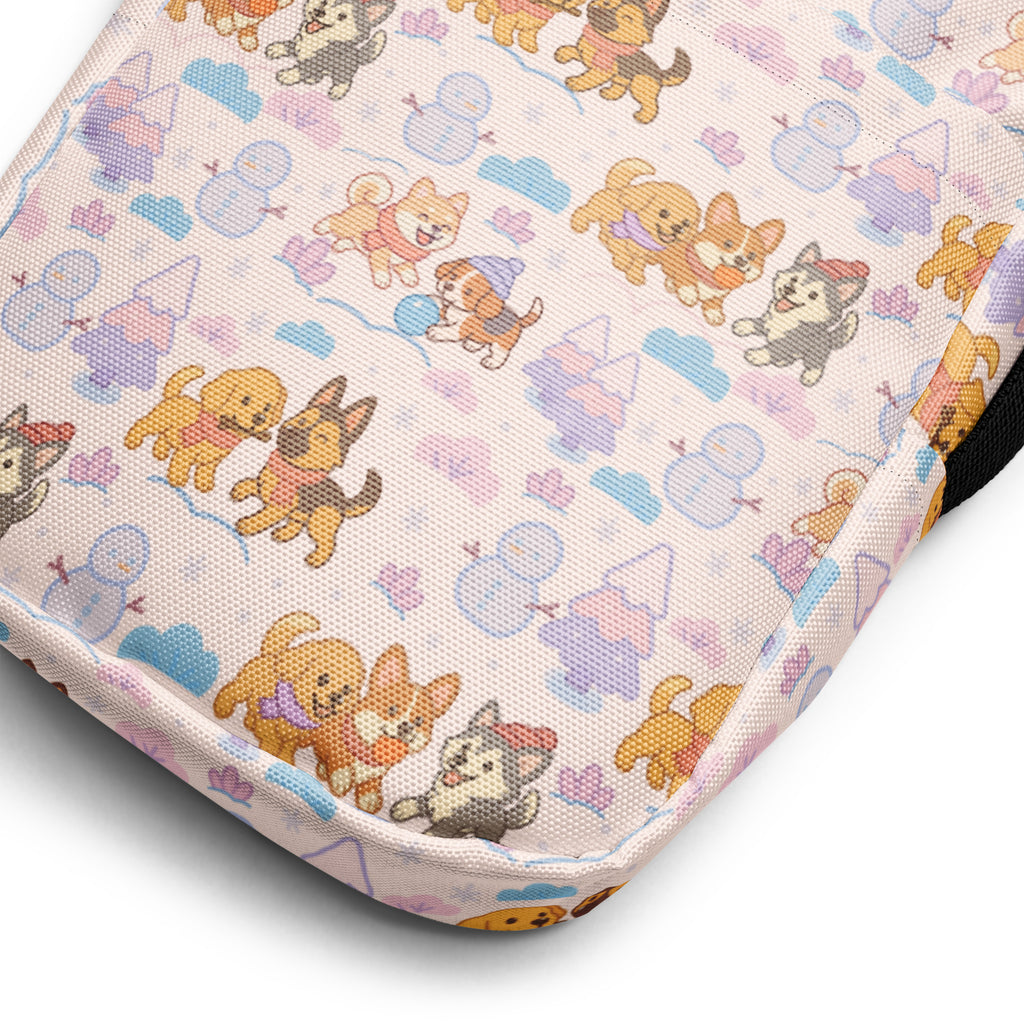 A soft pink fabric crossbody purse with a playful cartoon dogs and snowmen pattern for women at Christmas