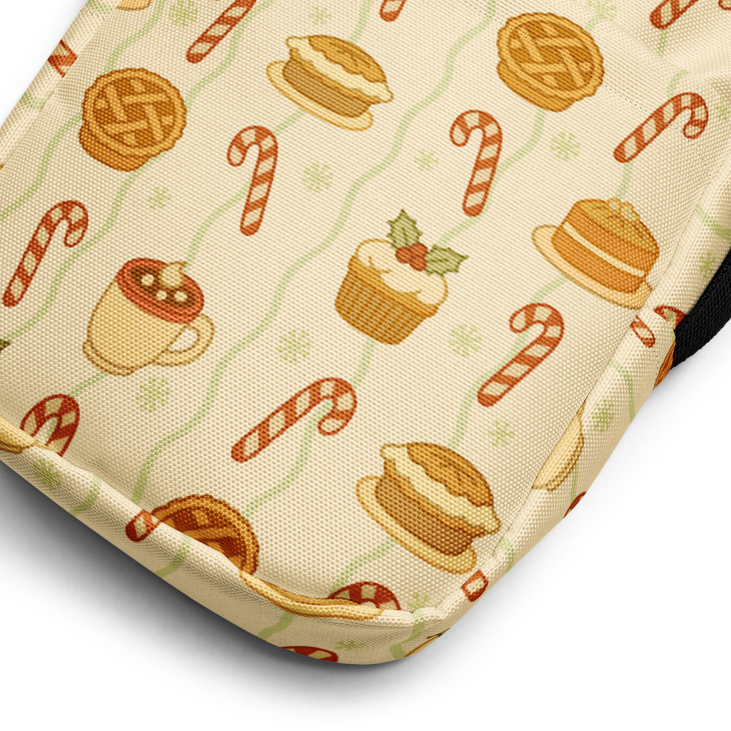 Cream-colored fabric crossbody purse with festive caramel apple pie candy cane and hot cocoa pattern in warm tones