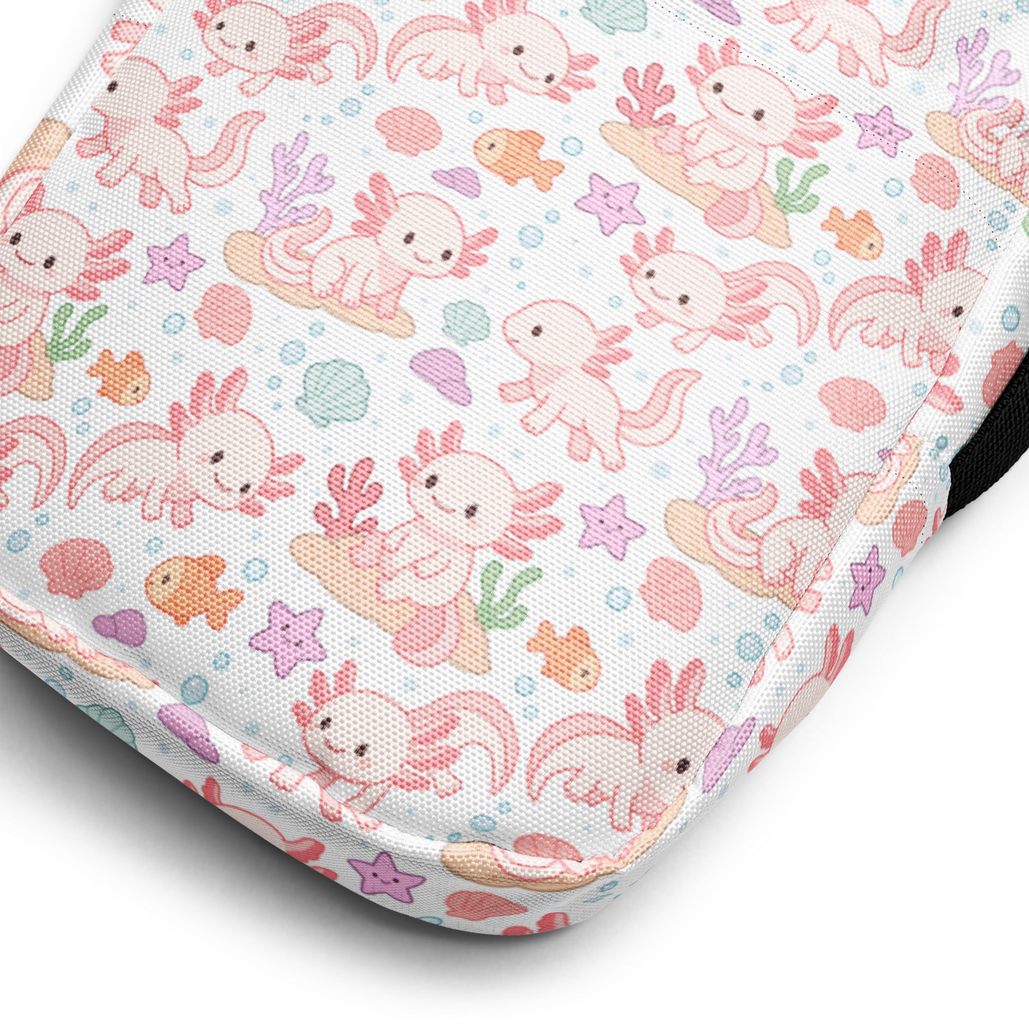 A white fabric girls axolotl crossbody purse with a cute pink axolotl and pastel sea creatures pattern